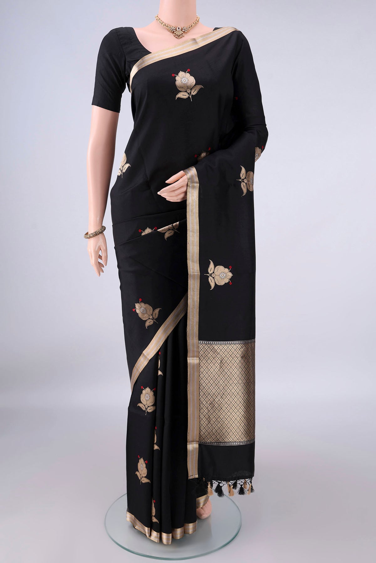 Pure Silk Black Banarasi Katan Saree with Zari Butta on the body and Zari Border.  displayed on a mannequin
