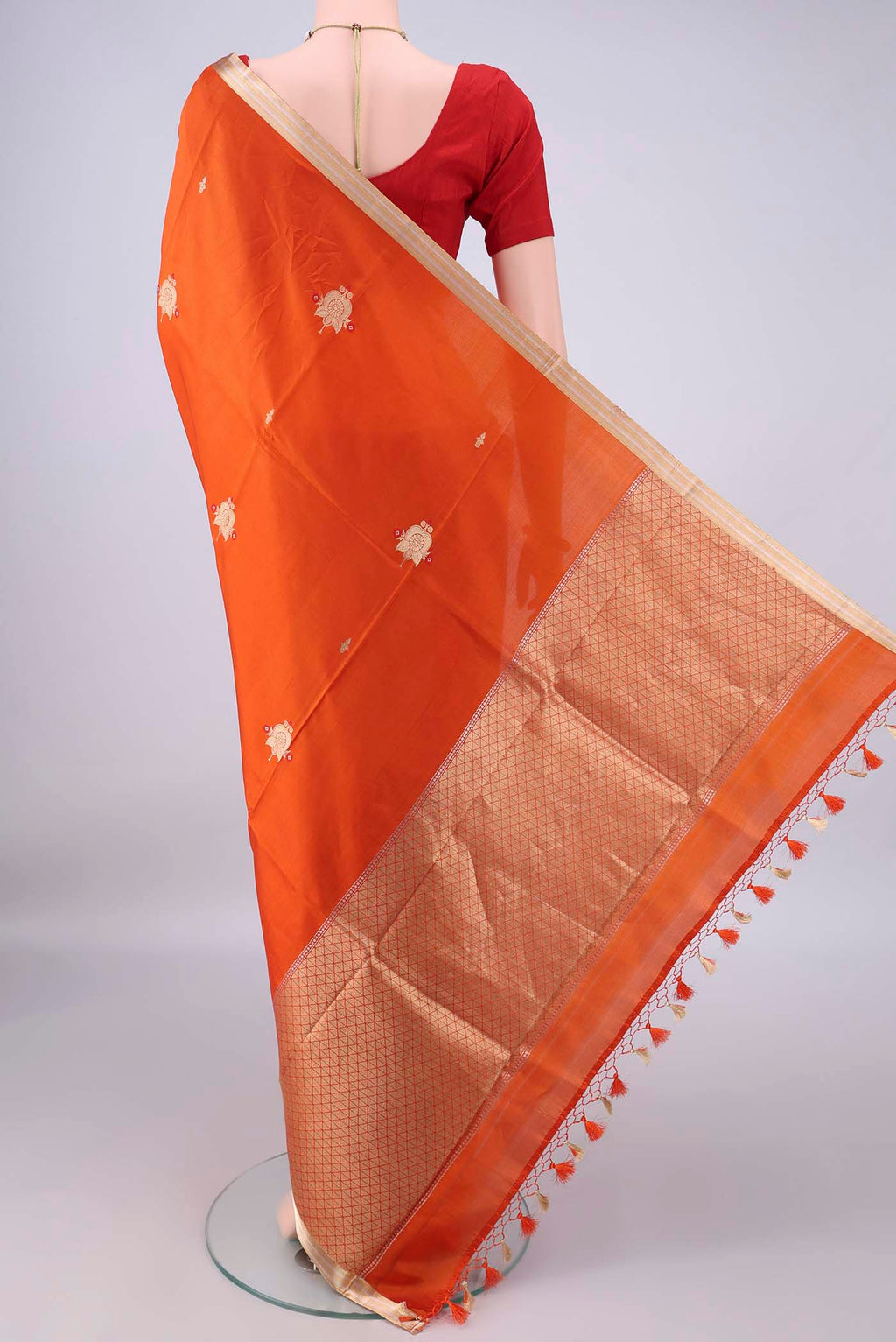 Flat view of Pure Silk Orange Banarasi Katan Saree with Zari Butta on the body and Zari Border. 