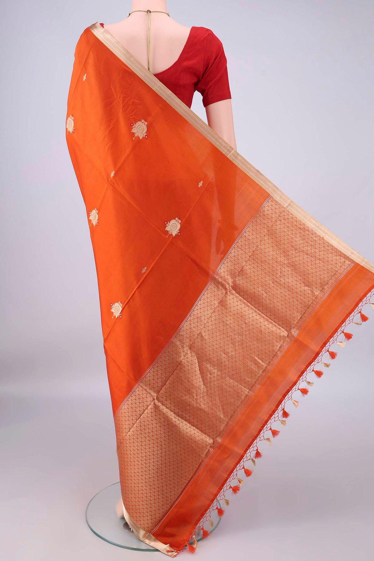 Flat view of Pure Silk Orange Banarasi Katan Saree with Zari Butta on the body and Zari Border. 