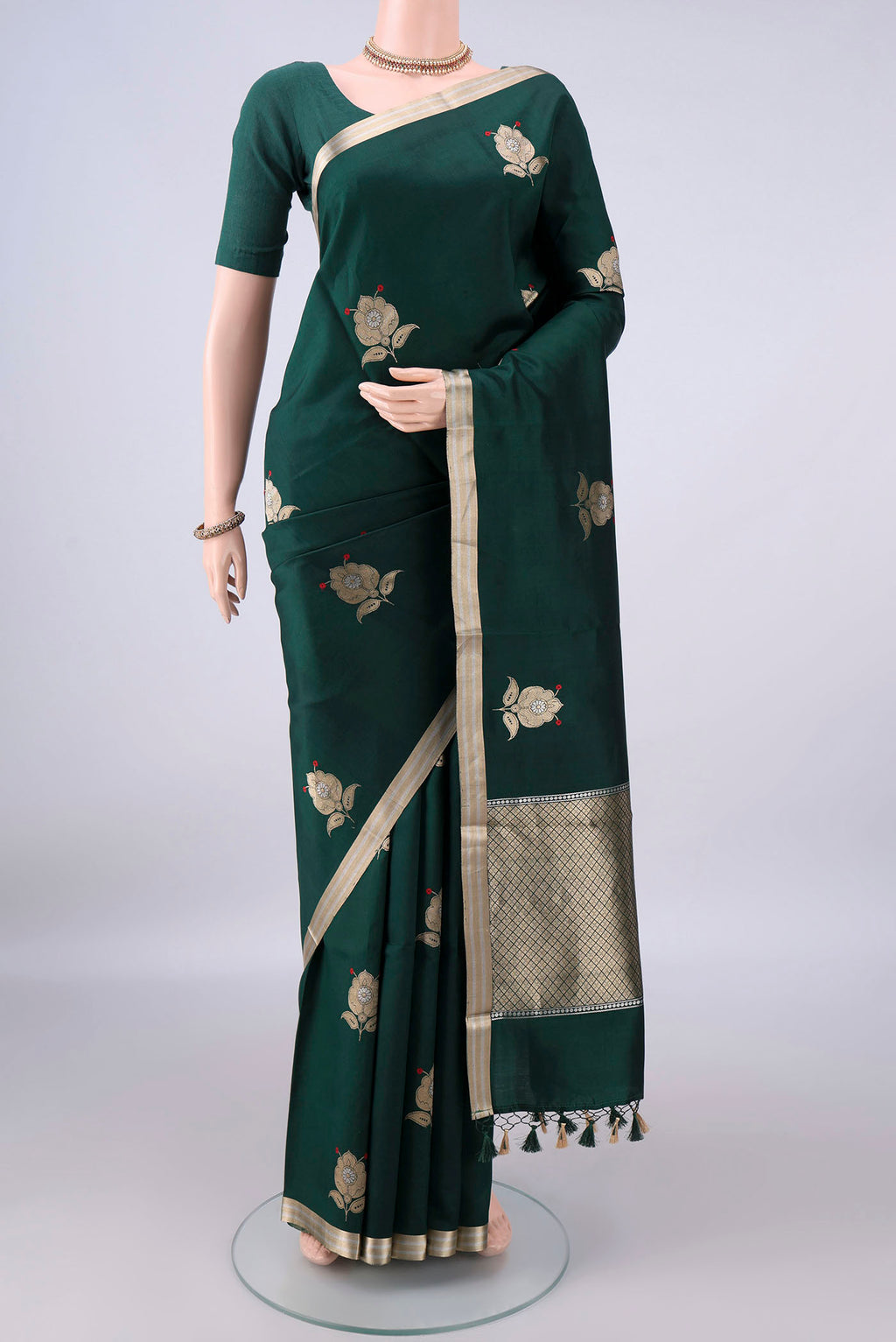 Pure Silk Bottle Green Banarasi Katan Saree with Zari Butta on the body and Zari Border.  displayed on a mannequin