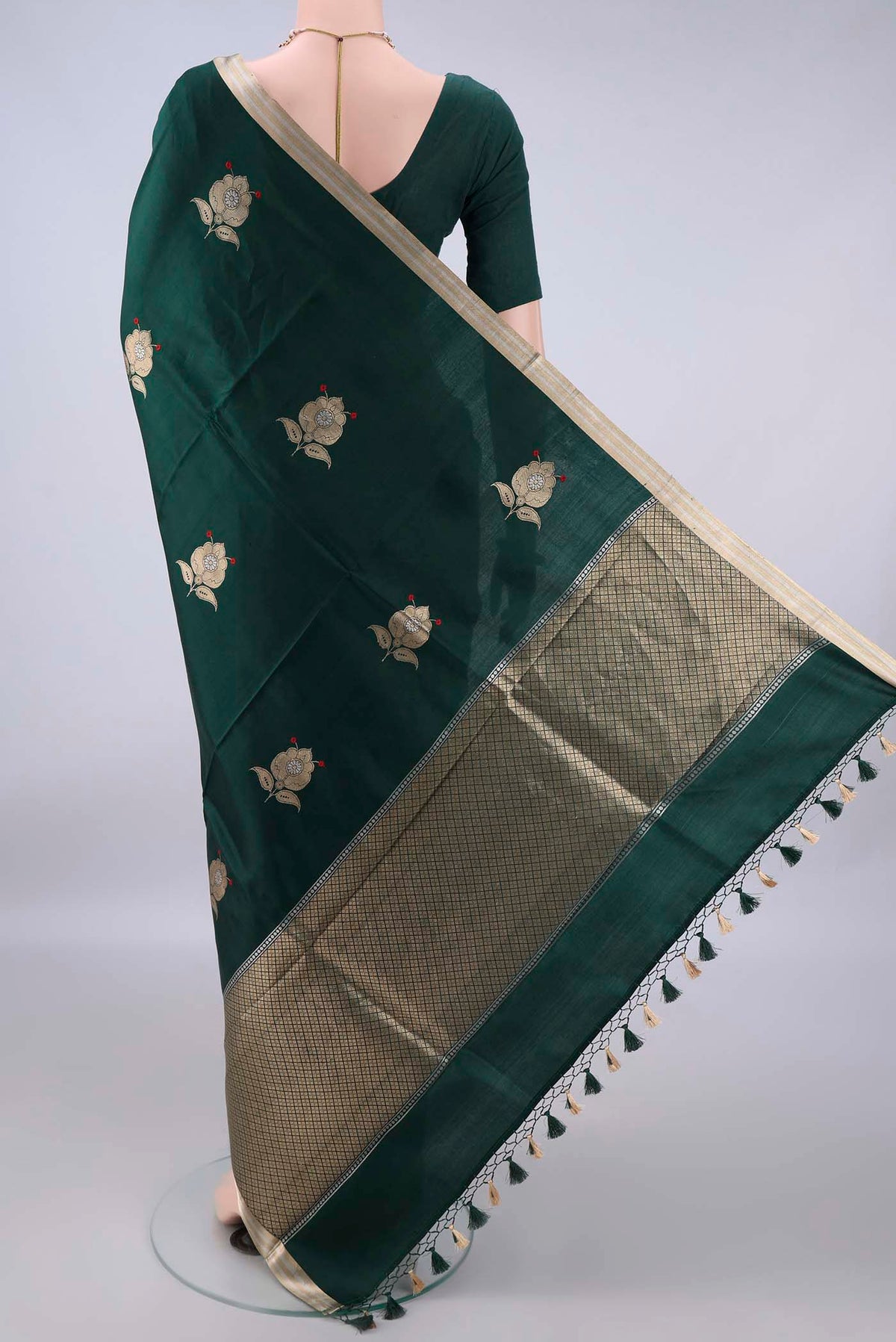 Flat view of Pure Silk Bottle Green Banarasi Katan Saree with Zari Butta on the body and Zari Border. 