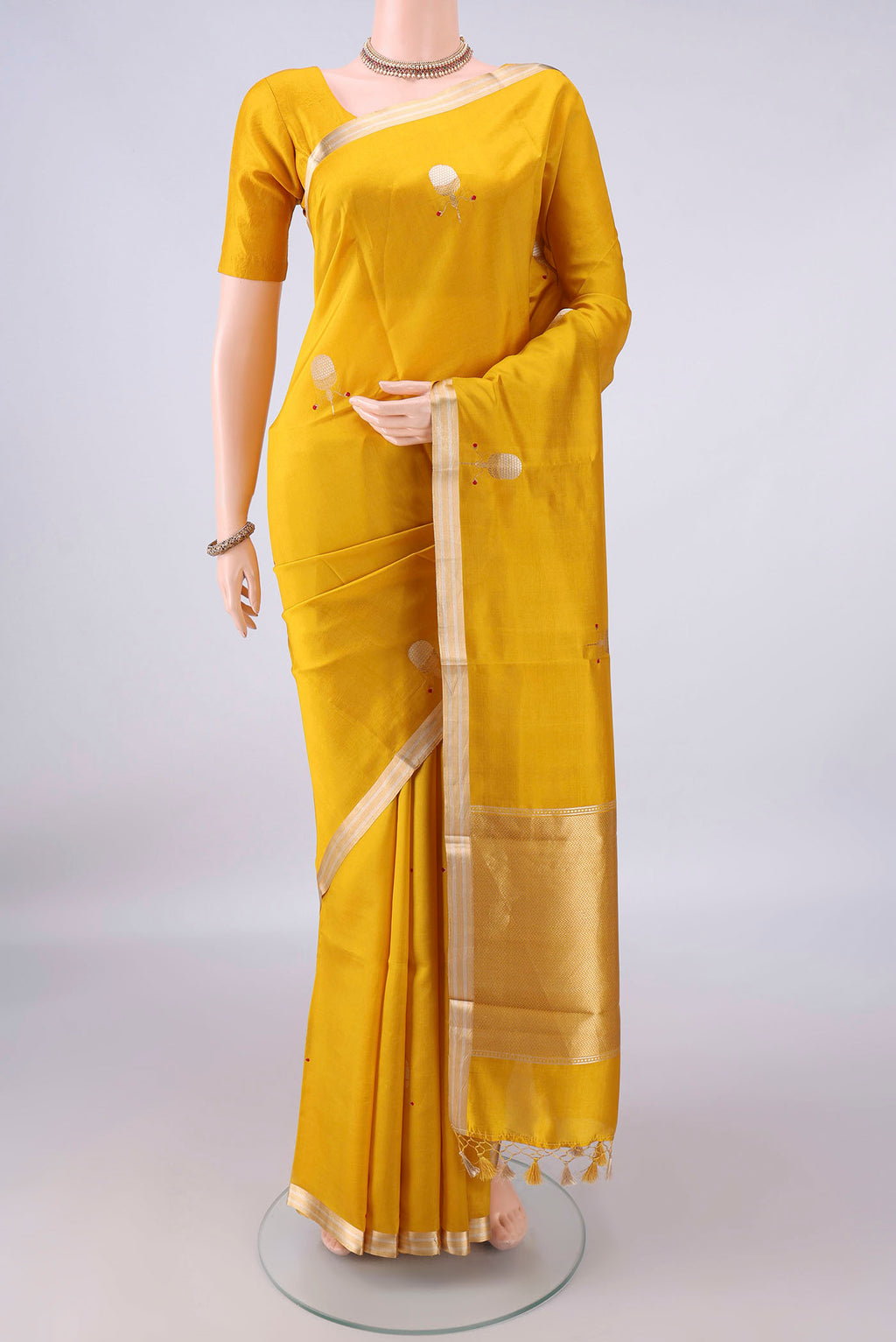 Pure Silk Yellow Banarasi Katan Saree with Zari Butta on the body and Zari Border.  displayed on a mannequin