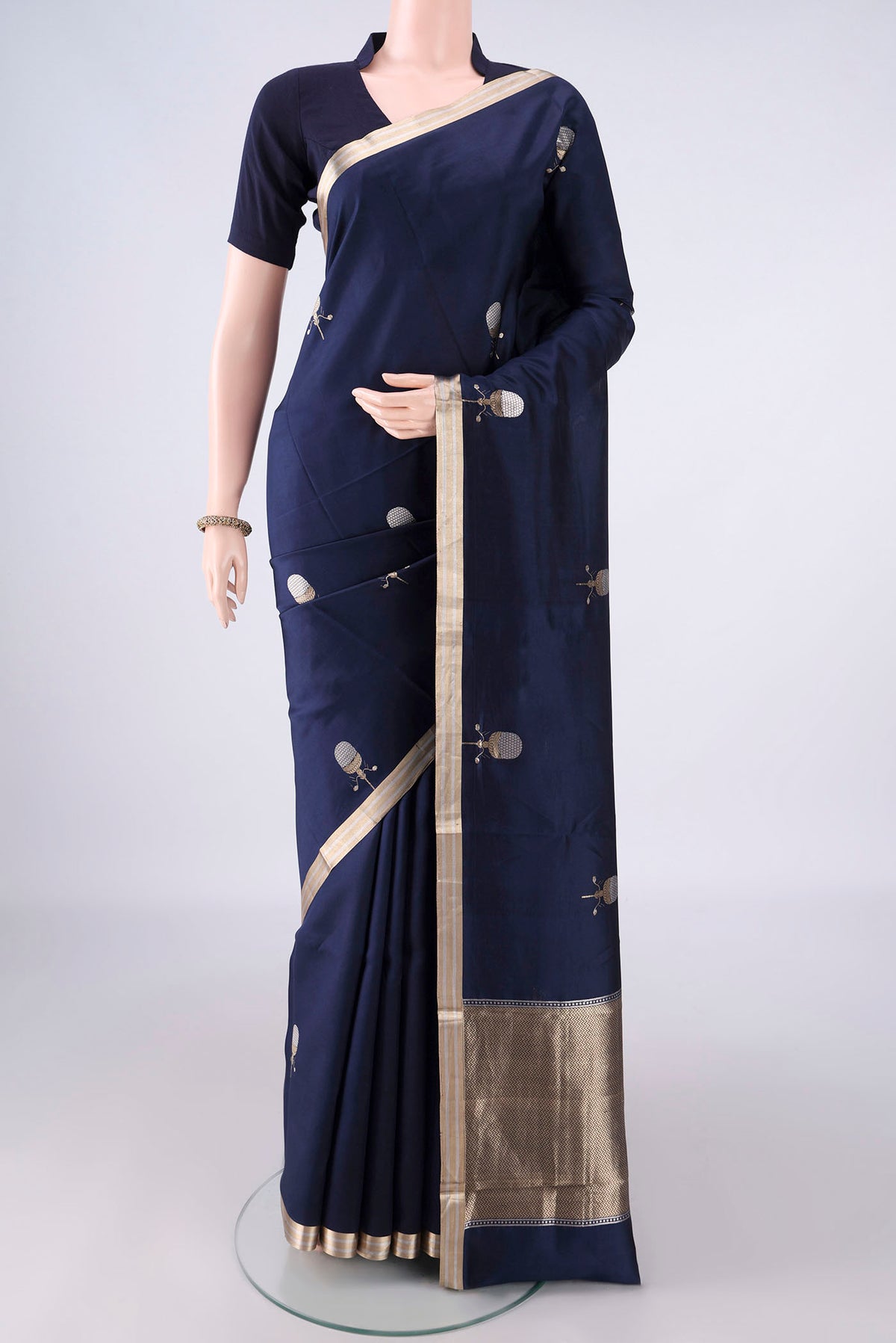 Pure Silk Navy Blue Banarasi Saree with Zari Butta on the body and Zari Border.  displayed on a mannequin