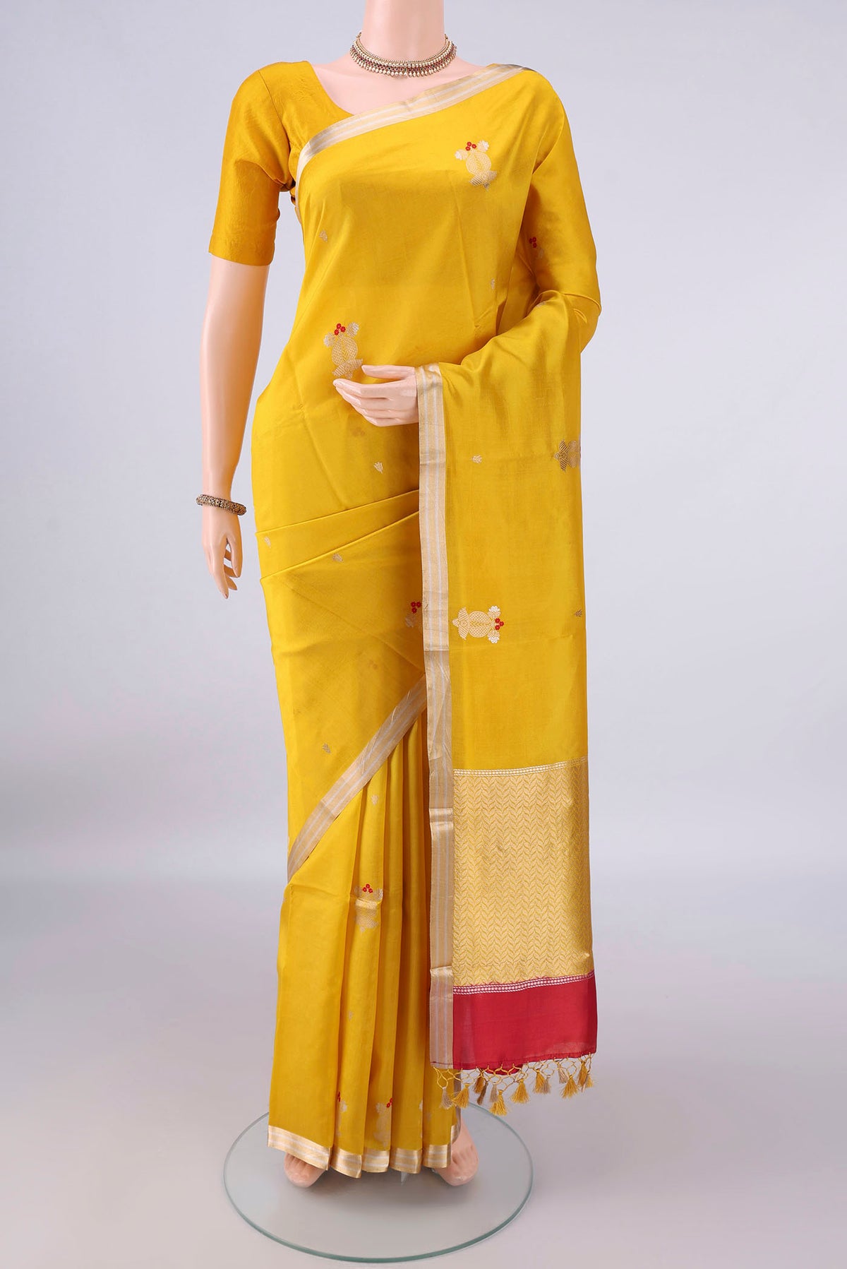 Pure Silk Yellow Banarasi Katan Saree with Zari Butta on the body and Zari Border.  displayed on a mannequin