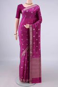 Pure Silk Magenta Banarasi Raw Saree with Zari Butta on the body and Zari Border.  displayed on a mannequin
