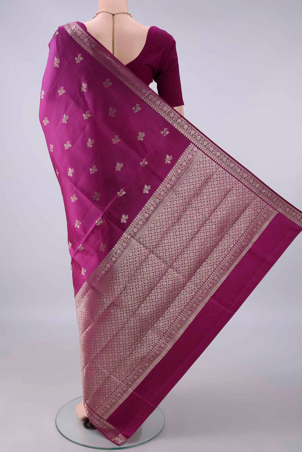 Flat view of Pure Silk Magenta Banarasi Raw Saree with Zari Butta on the body and Zari Border. 