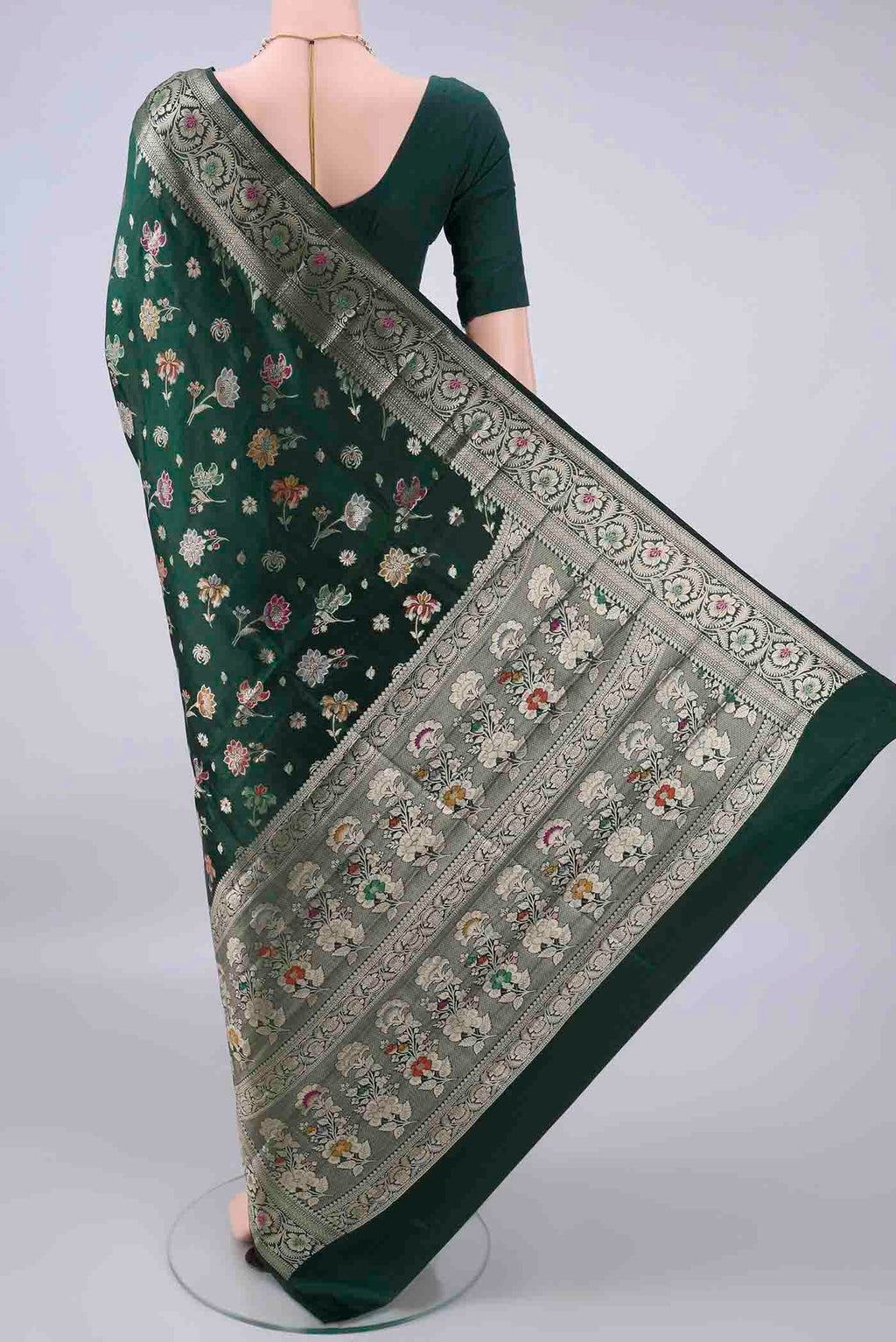 Flat view of Pure Silk Bottle Green Banarasi Raw Saree with Zari Butta on the body and Zari And Thread Border. 