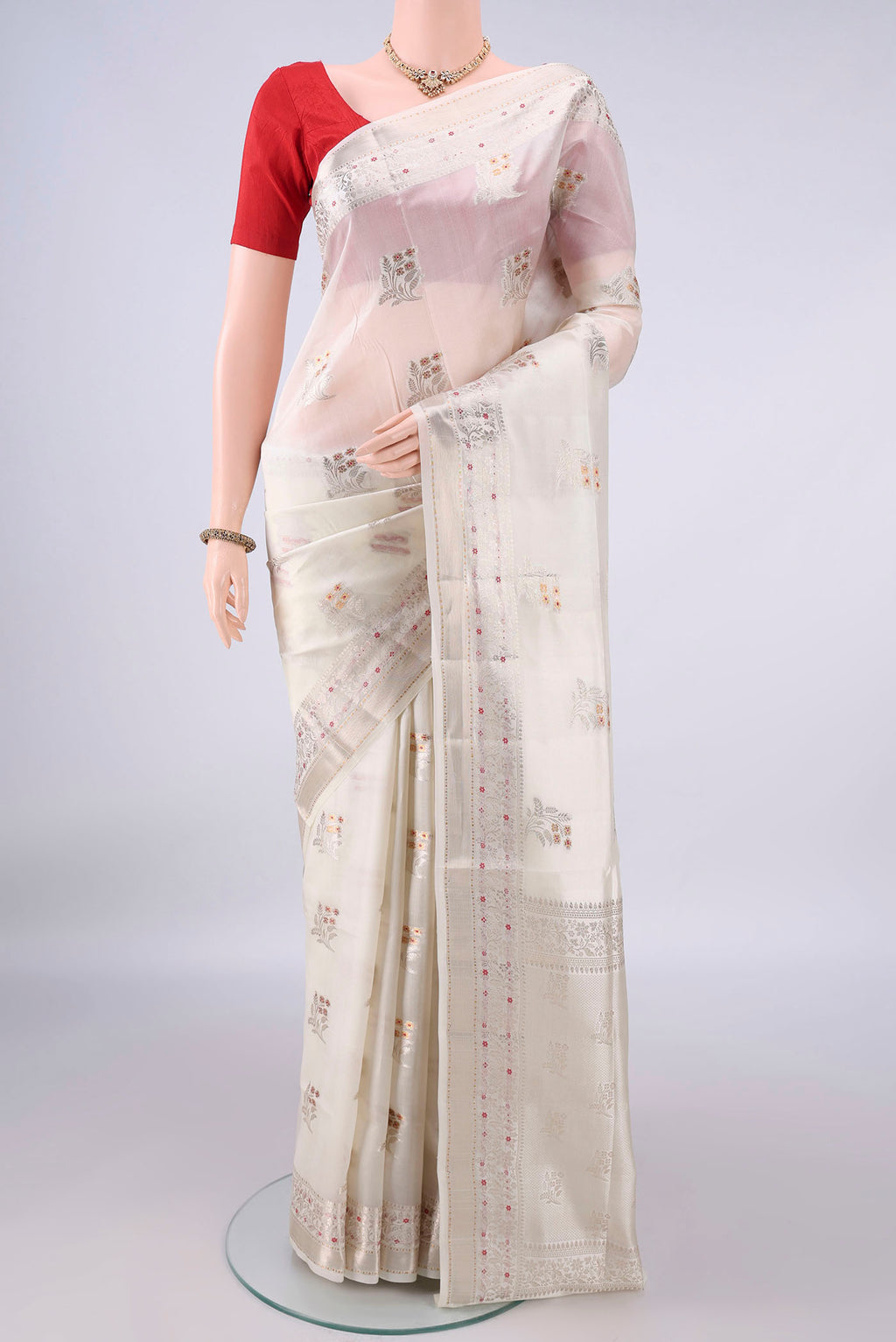 Pure Silk Off White Banarasi Raw Saree with Zari Butta on the body and Zari And Thread Border.  displayed on a mannequin