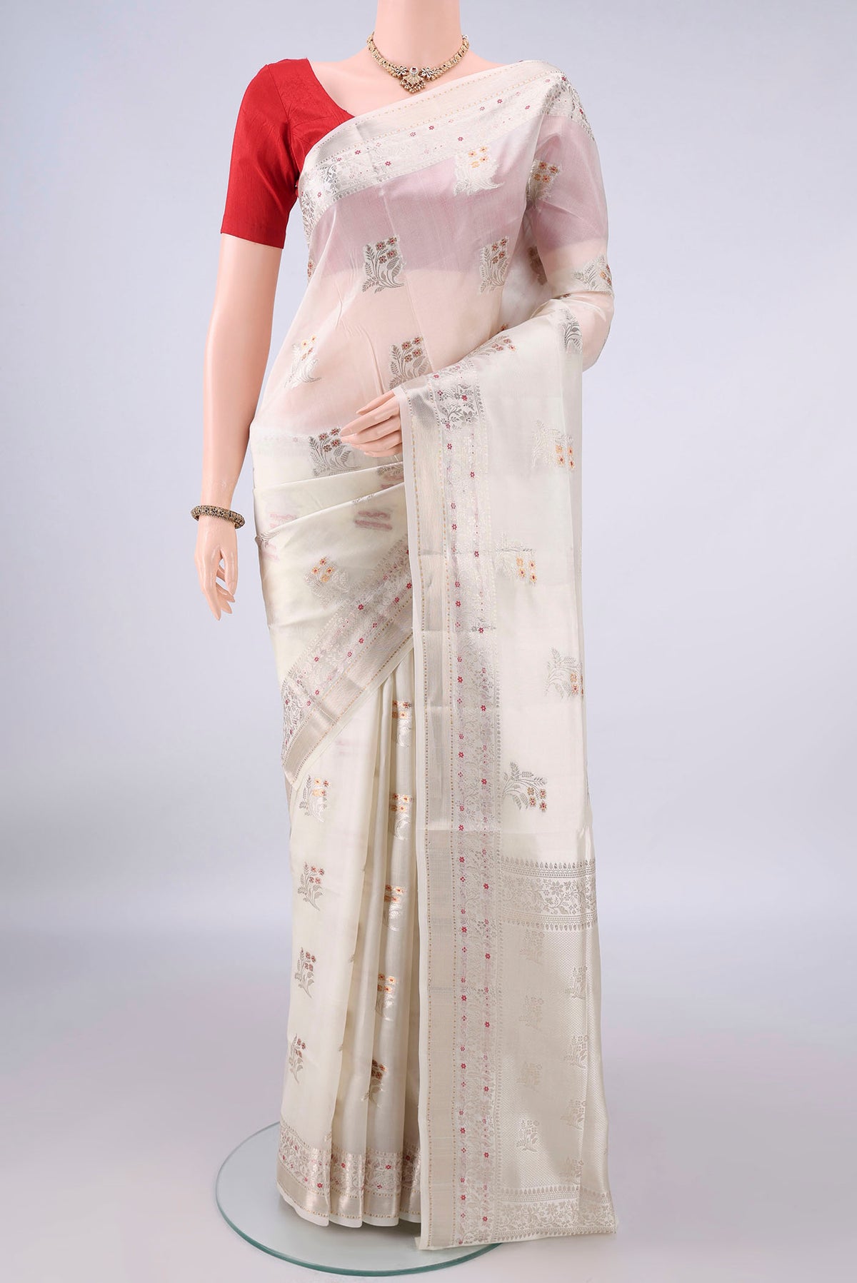 Pure Silk Off White Banarasi Raw Saree with Zari Butta on the body and Zari And Thread Border.  displayed on a mannequin
