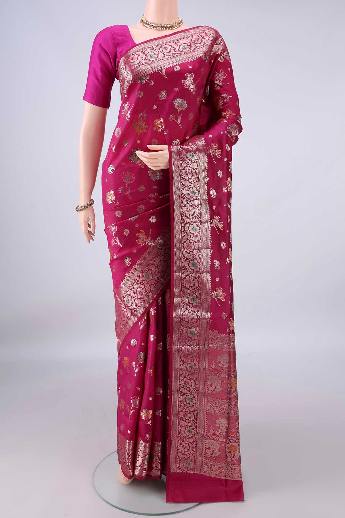 Pure Silk Rani Pink Banarasi Raw Saree with Zari Butta on the body and Zari And Thread Border.  displayed on a mannequin