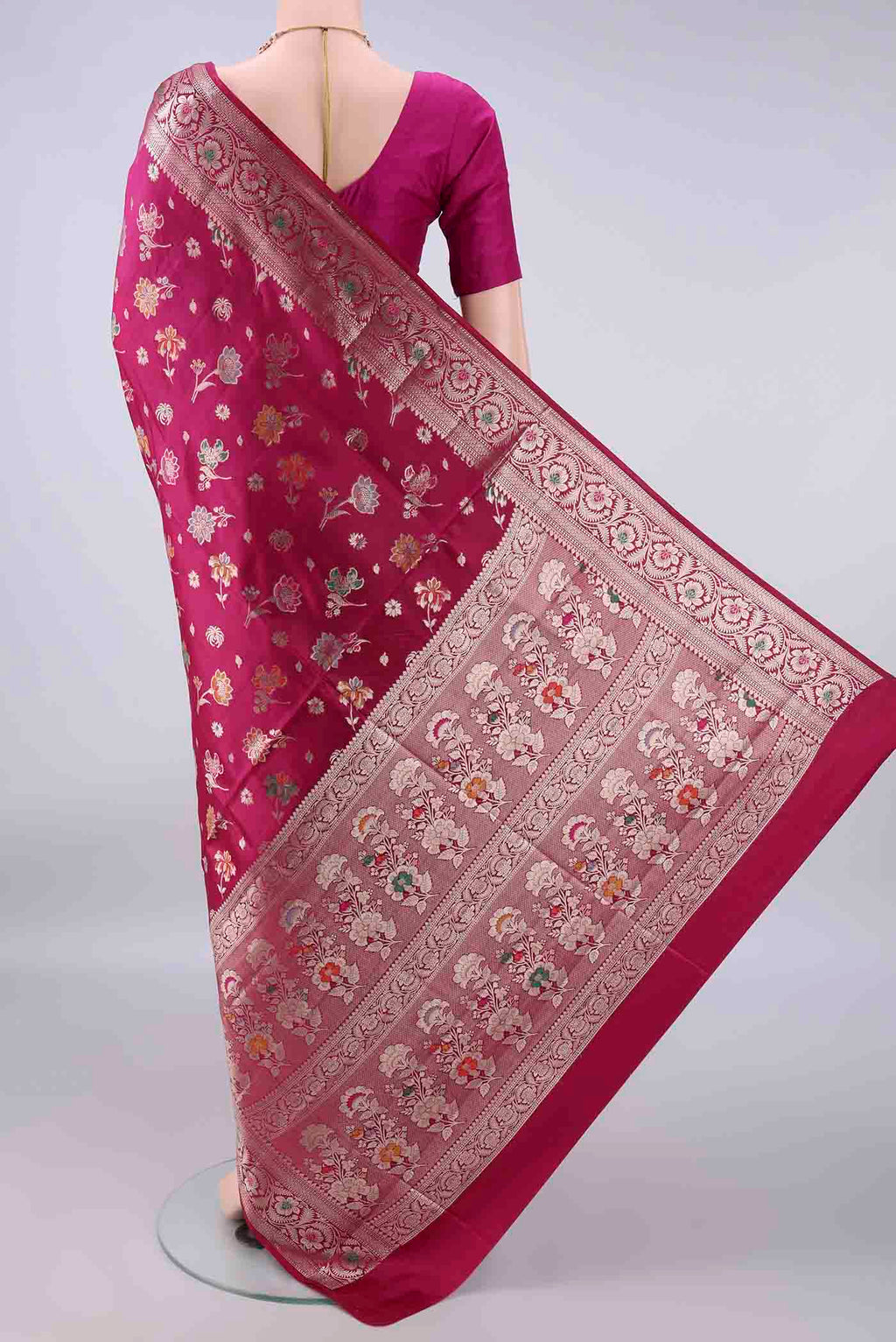 Flat view of Pure Silk Rani Pink Banarasi Raw Saree with Zari Butta on the body and Zari And Thread Border. 