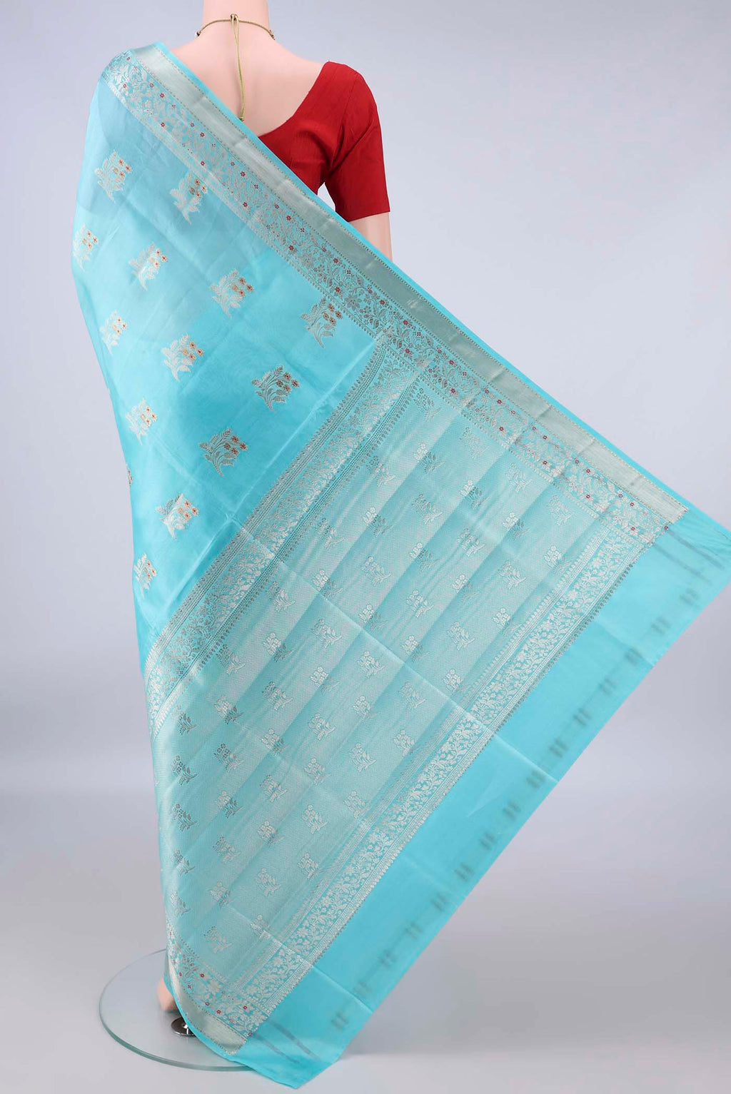 Flat view of Pure Silk Sky Blue Banarasi Raw Saree with Zari Butta on the body and Zari Border. 