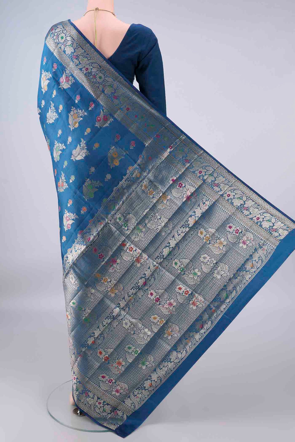 Flat view of Pure Silk Blue Banarasi Raw Saree with Zari Butta on the body and Zari And Thread Border. 