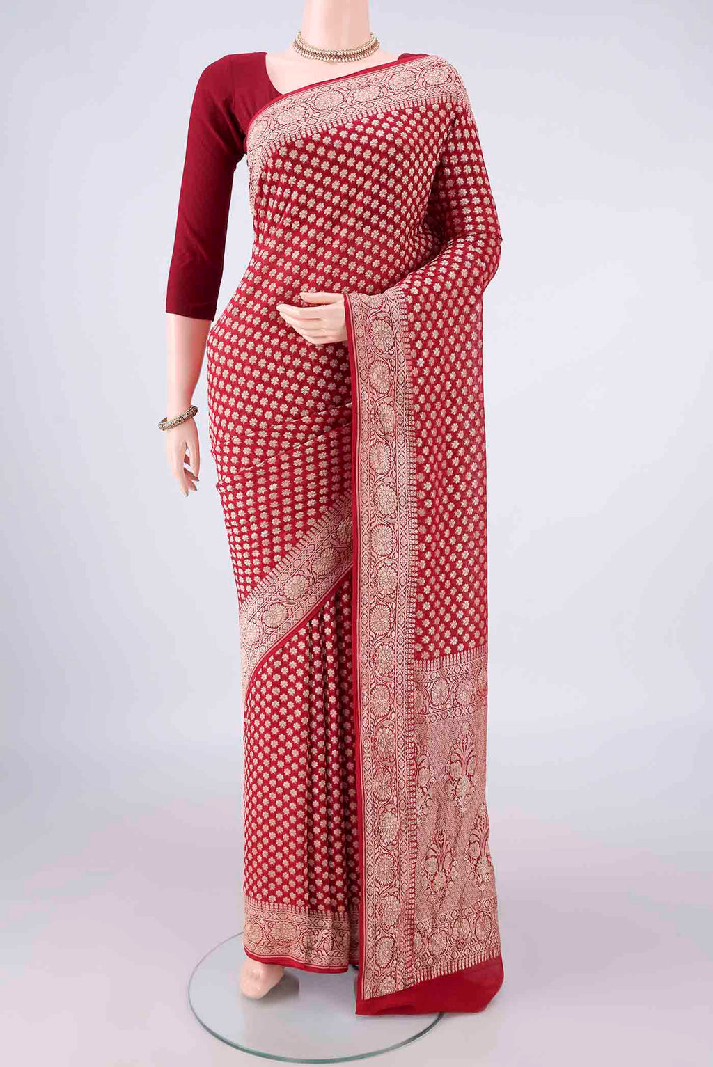 Red Banarasi Georgette Saree with Zari Butta on the body and Zari Border.  displayed on a mannequin