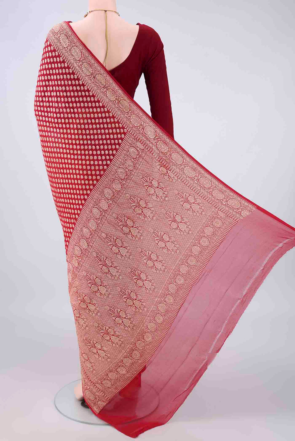 Flat view of Red Banarasi Georgette Saree with Zari Butta on the body and Zari Border. 