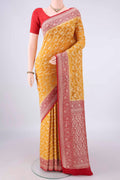 Yellow Banarasi Georgette Saree with Zari Brocade on the body and Zari Border.  displayed on a mannequin