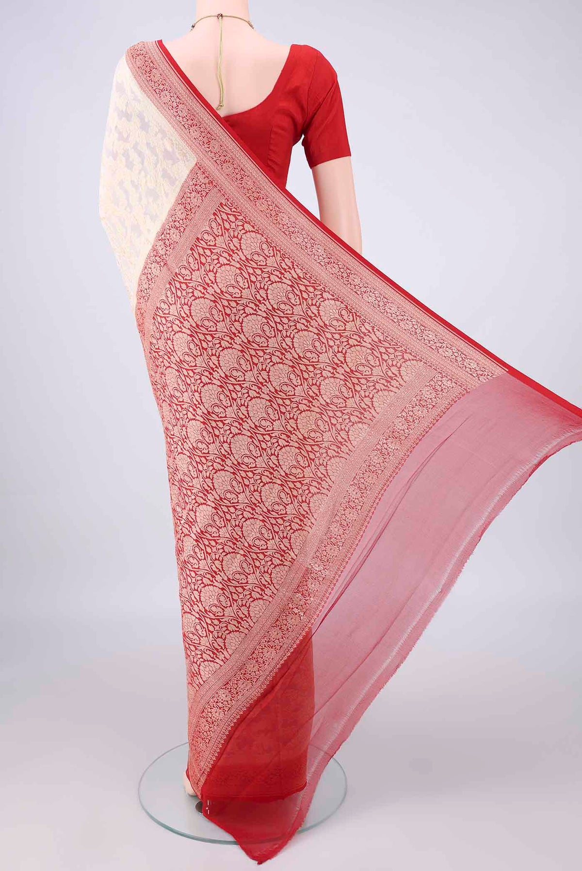 Flat view of Cream Banarasi Georgette Saree with Zari Butta on the body and Zari Border. 