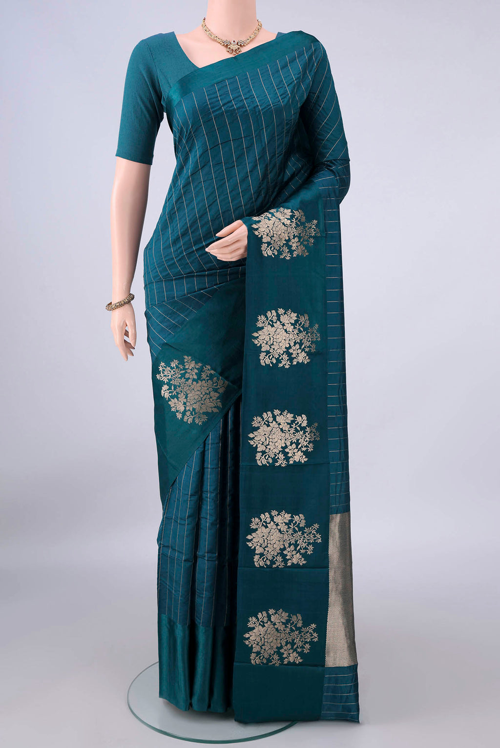 Pure Silk Teal Banarasi Katan Saree with Stripes on the body and Zari Border.  displayed on a mannequin