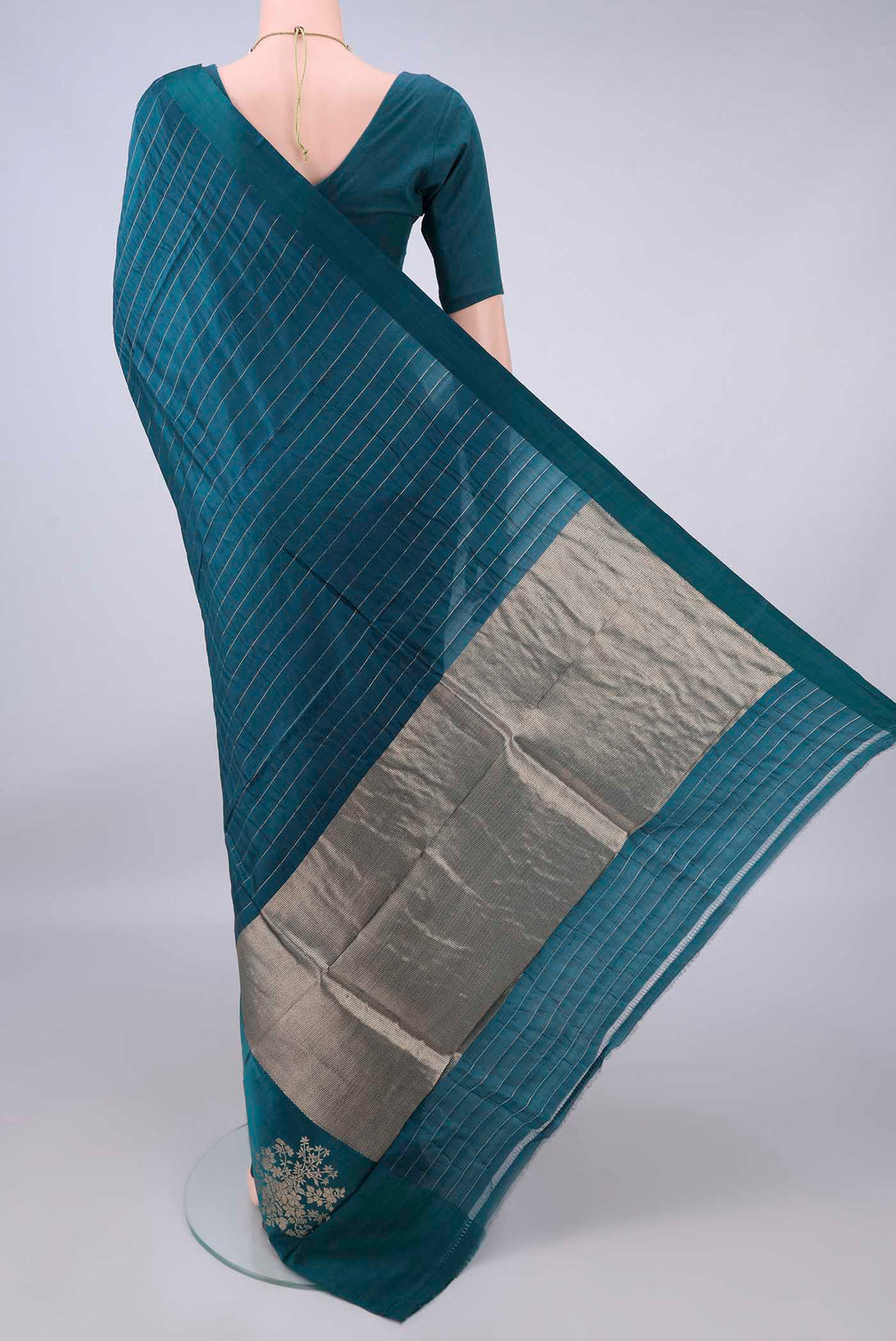 Flat view of Pure Silk Teal Banarasi Katan Saree with Stripes on the body and Zari Border. 