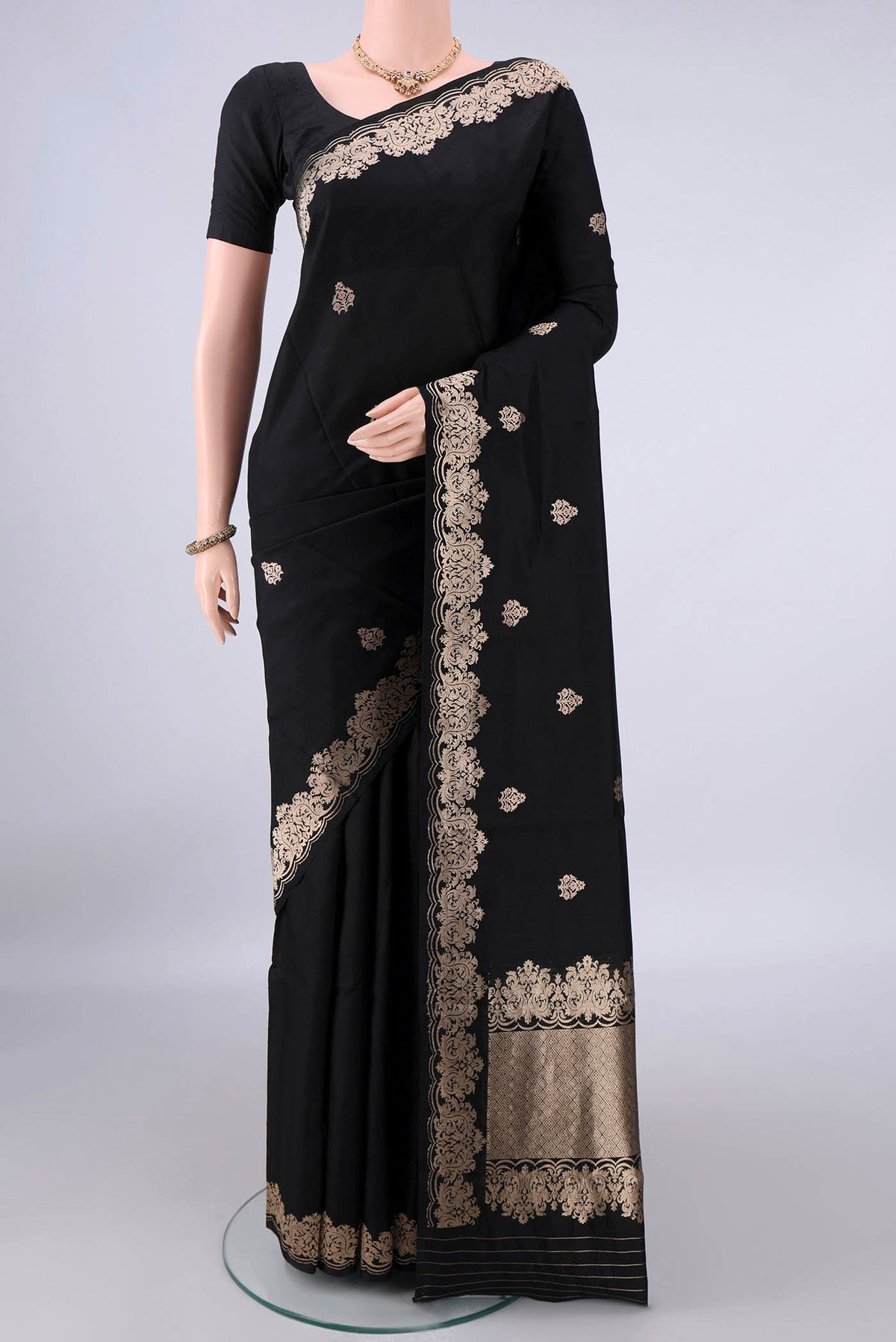 Pure Silk Black Banarasi Katan Saree with Zari Butta on the body and Zari Border.  displayed on a mannequin