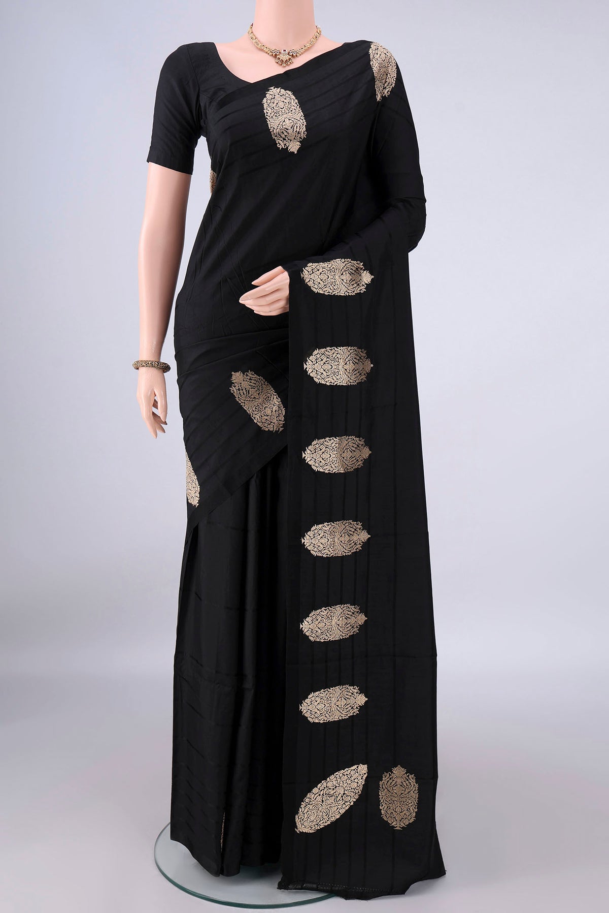 Pure Silk Black Banarasi Katan Saree with Plain Body and Zari Border.  displayed on a mannequin