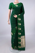 Pure Silk Bottle Green Banarasi Katan Saree with Zari Butta on the body and Zari Border.  displayed on a mannequin
