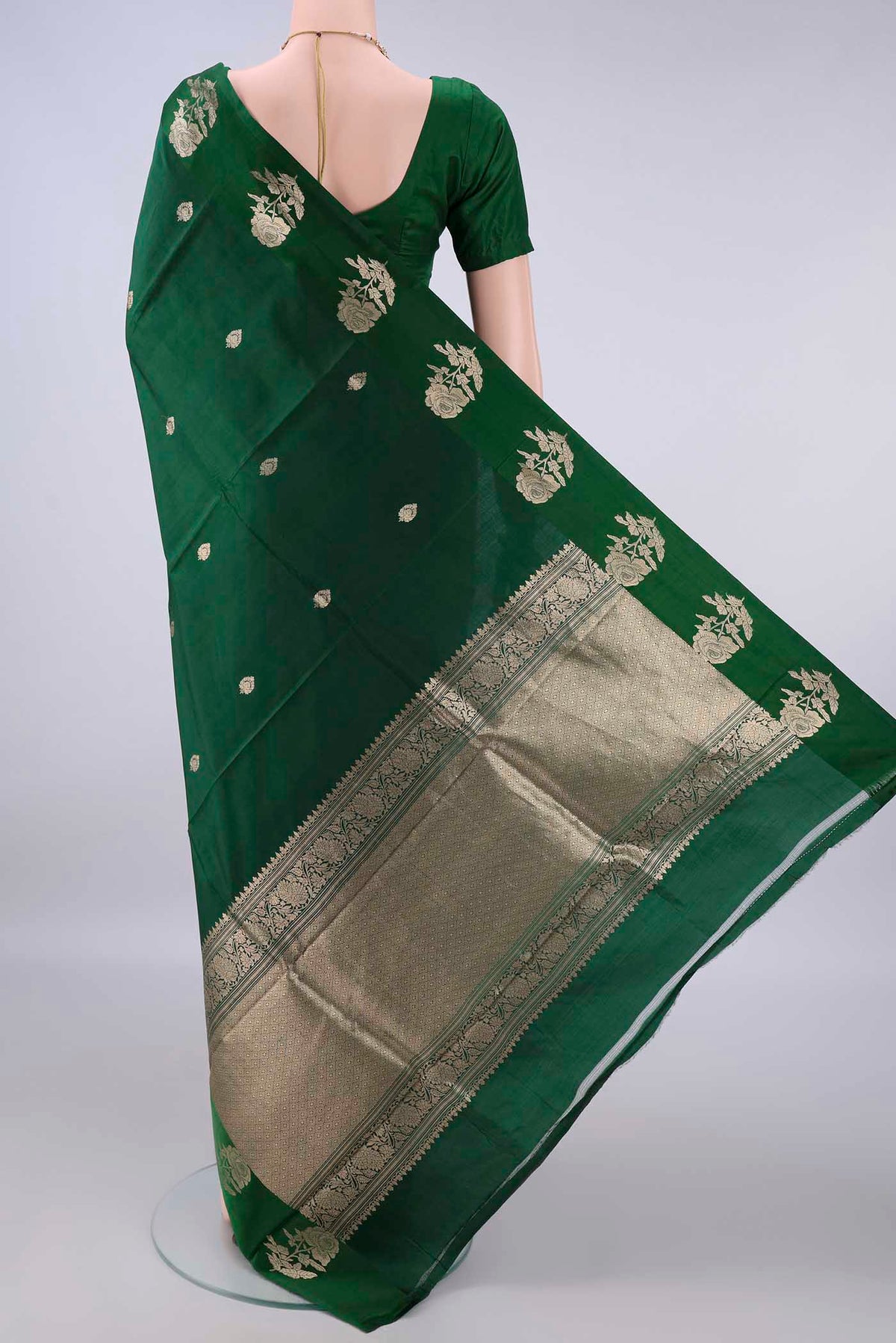 Flat view of Pure Silk Bottle Green Banarasi Katan Saree with Zari Butta on the body and Zari Border. 