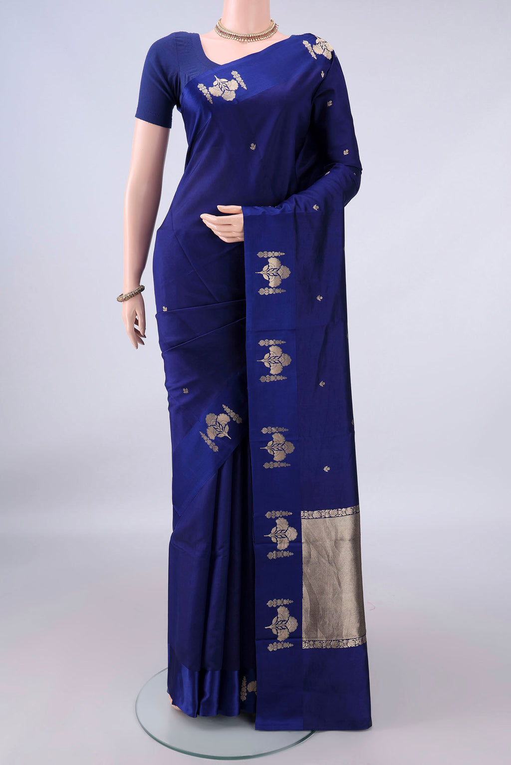 Pure Silk Navy Blue Banarasi Katan Saree with Zari Butta on the body and Zari Border.  displayed on a mannequin