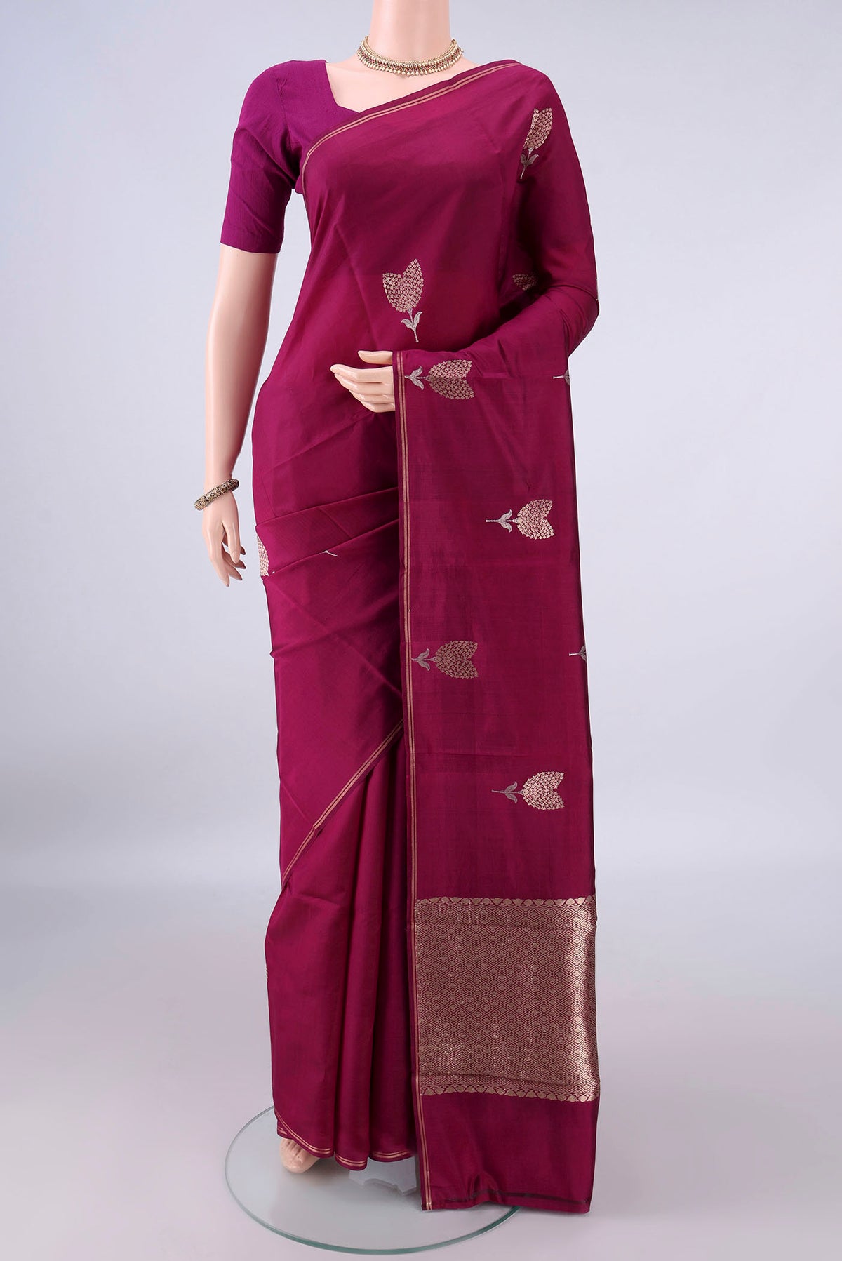 Pure Silk Magenta Banarasi Katan Saree with Zari Butta on the body and Zari Border.  displayed on a mannequin