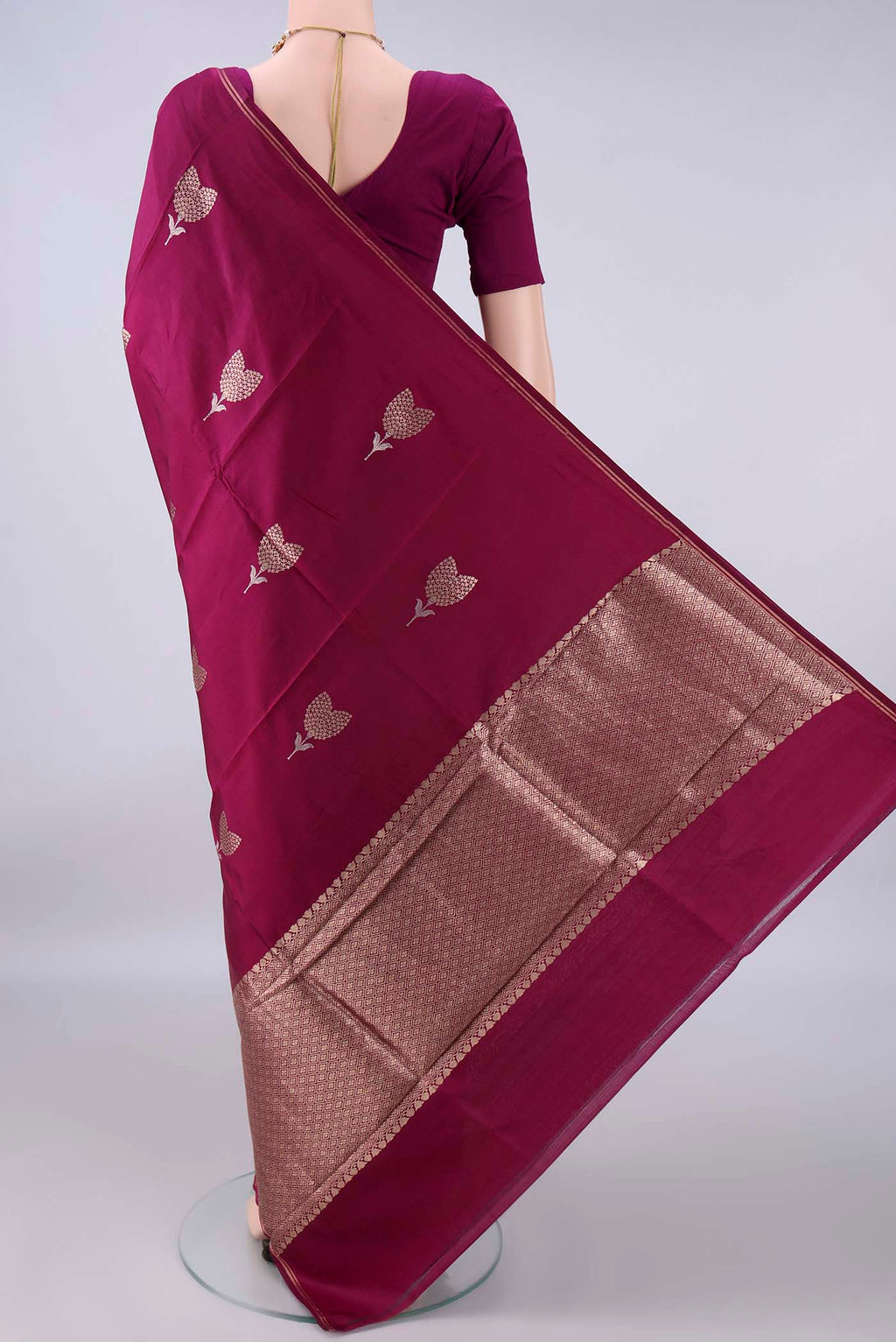 Flat view of Pure Silk Magenta Banarasi Katan Saree with Zari Butta on the body and Zari Border. 