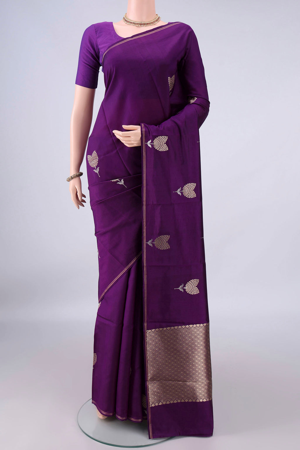 Pure Silk Violet Banarasi Katan Saree with Zari Butta on the body and Zari Border.  displayed on a mannequin