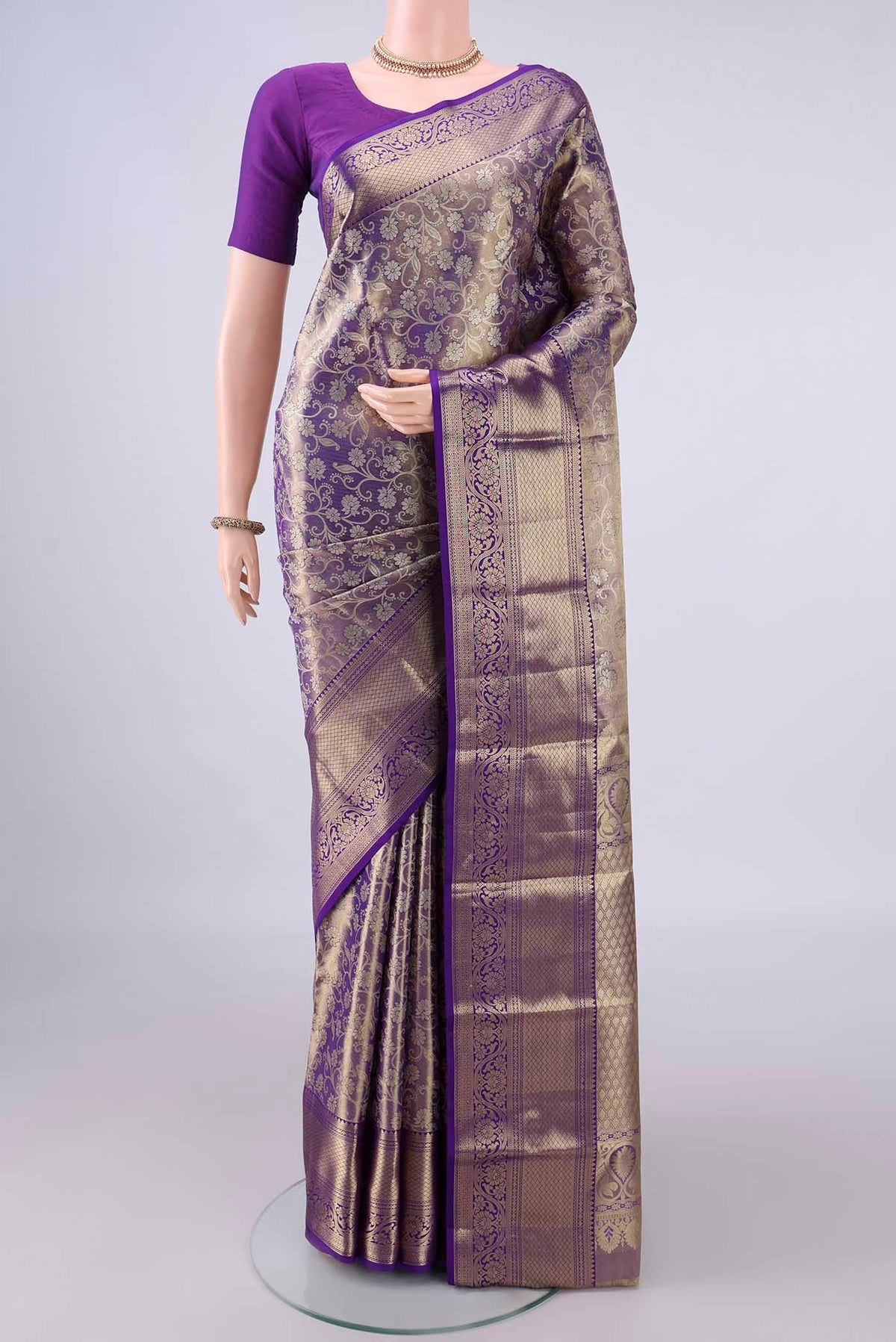 Purple Dual Tone Kanjivaram Tissue Saree with Zari Brocade on the body and Zari Border.  displayed on a mannequin