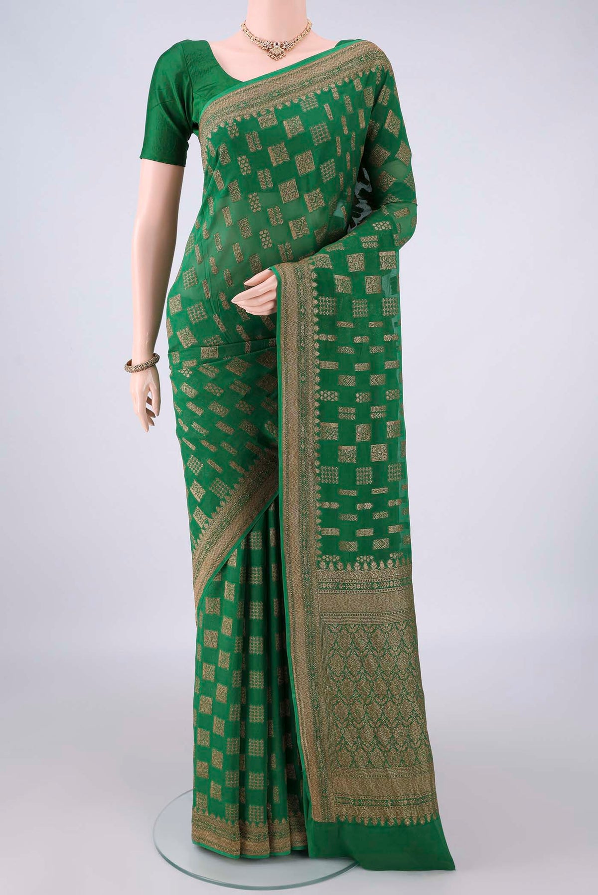 Green Banarasi Georgette Saree with Zari Butta on the body and Zari Border.  displayed on a mannequin