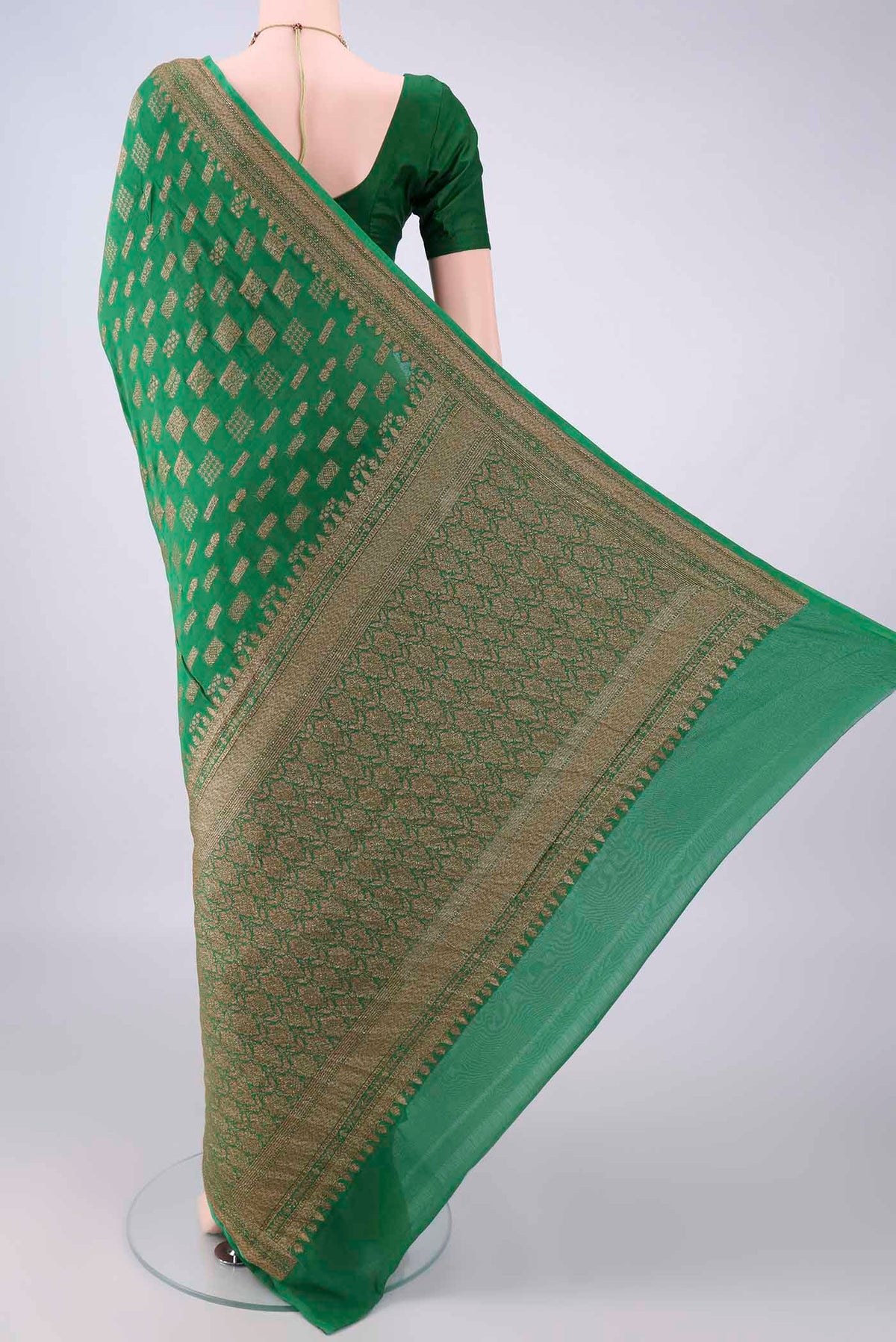 Flat view of Green Banarasi Georgette Saree with Zari Butta on the body and Zari Border. 