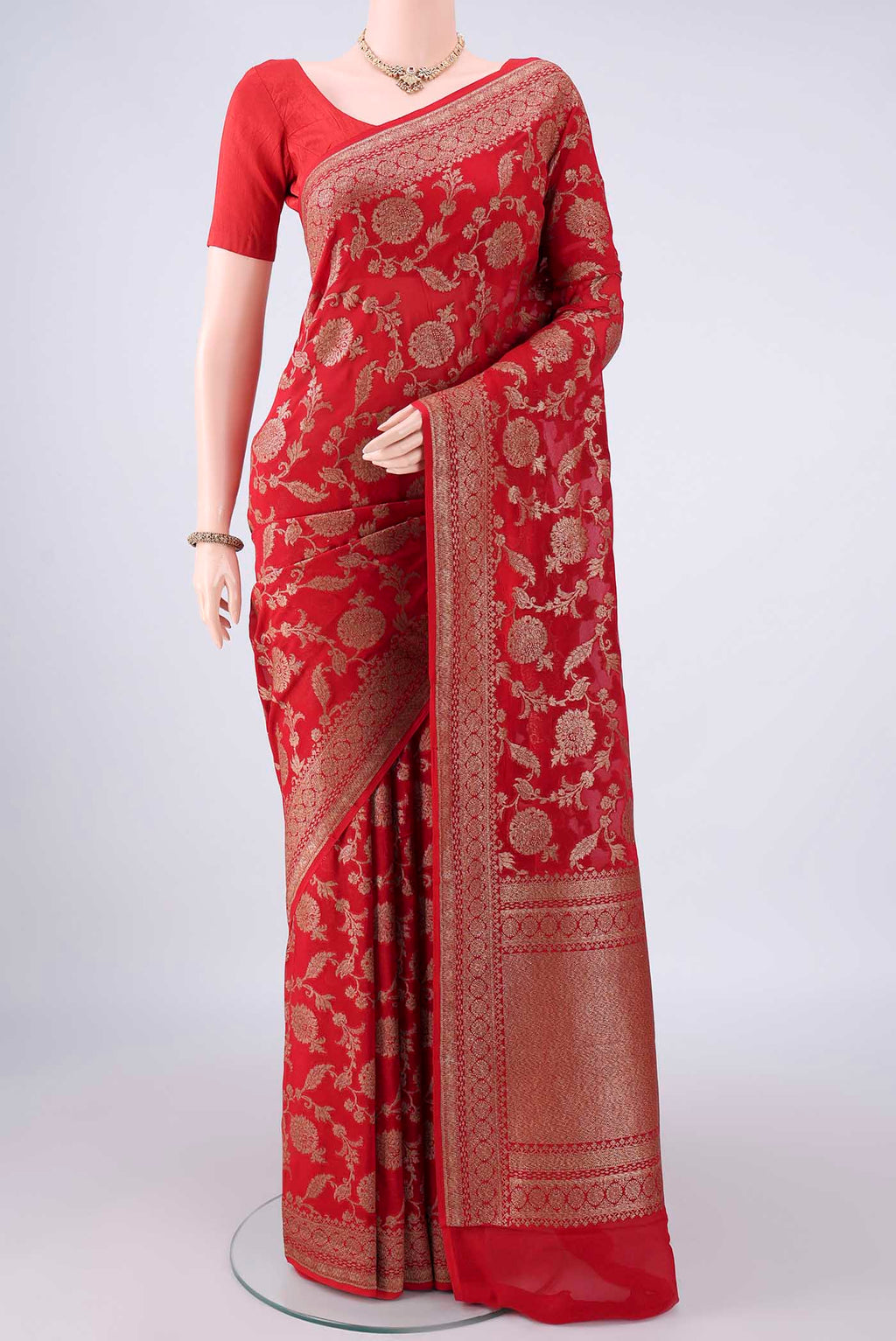 Red Banarasi Georgette Saree with Zari Brocade on the body and Zari Border.  displayed on a mannequin
