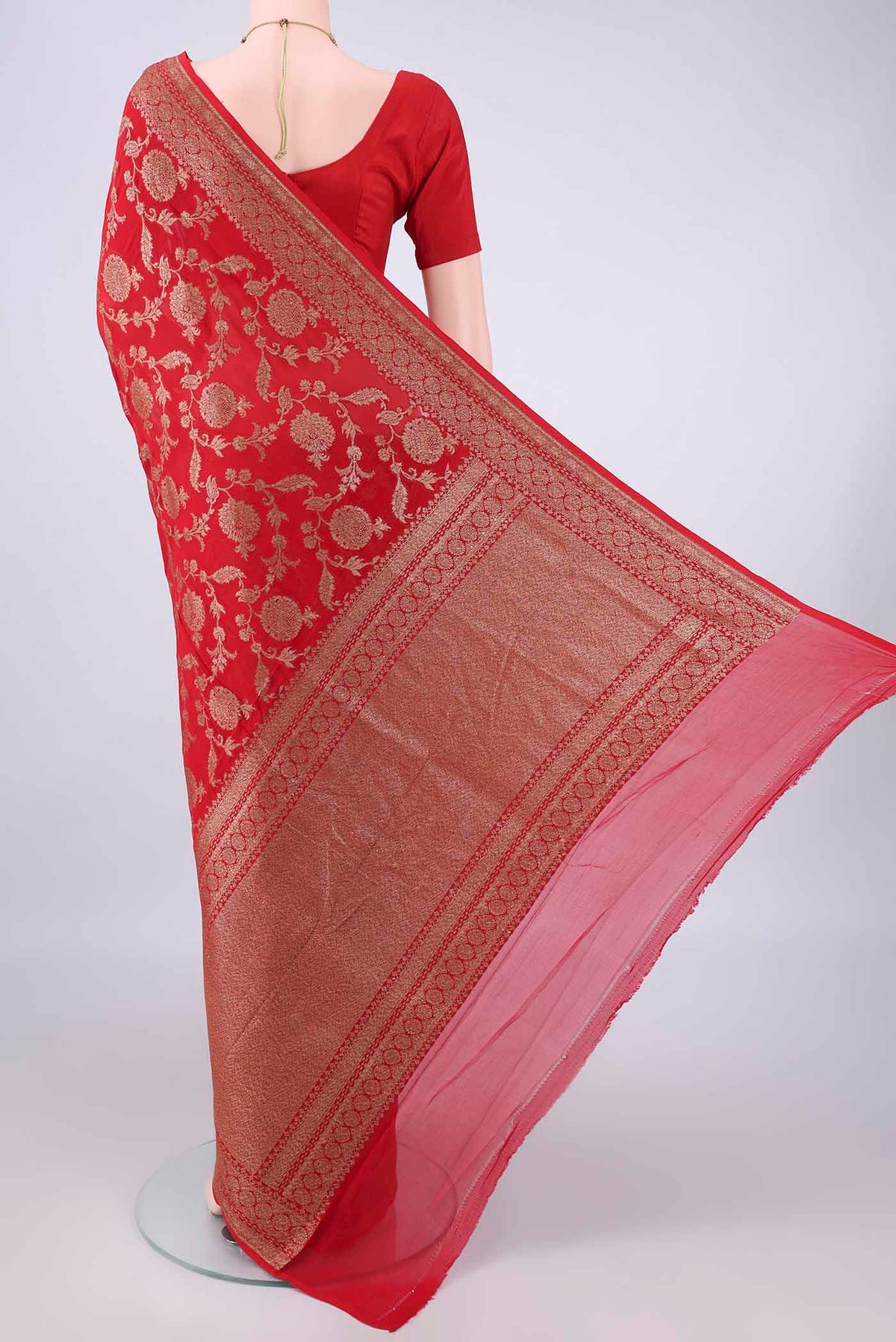 Flat view of Red Banarasi Georgette Saree with Zari Brocade on the body and Zari Border. 