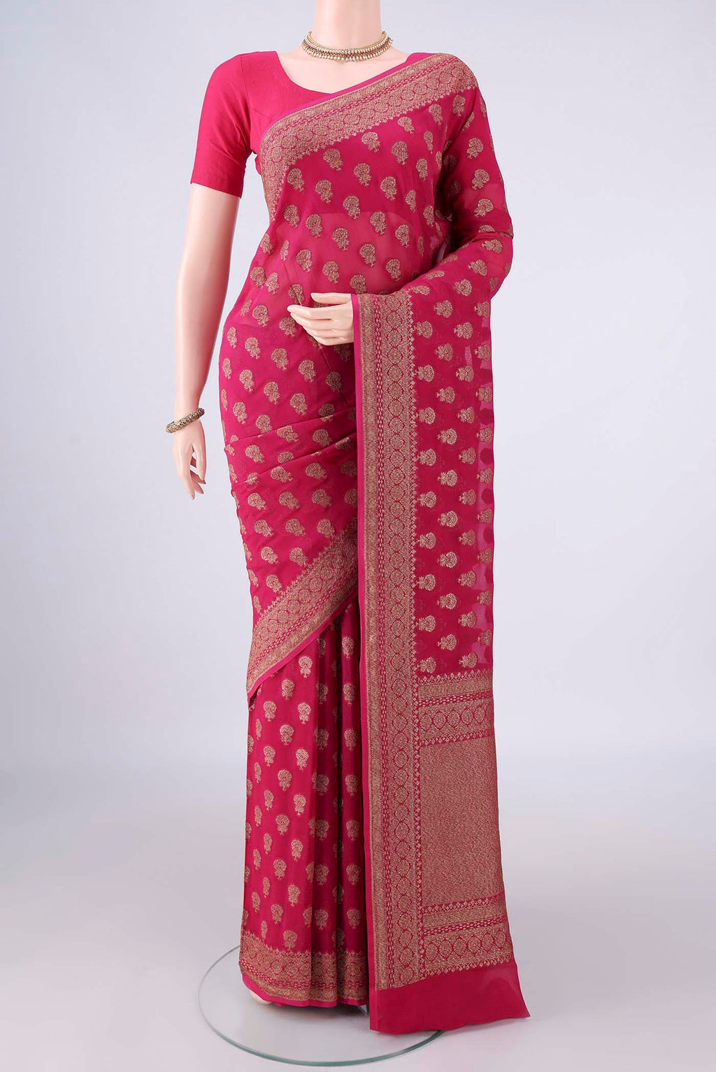 Rani Pink Banarasi Georgette Saree with Zari Butta on the body and Zari Border.  displayed on a mannequin