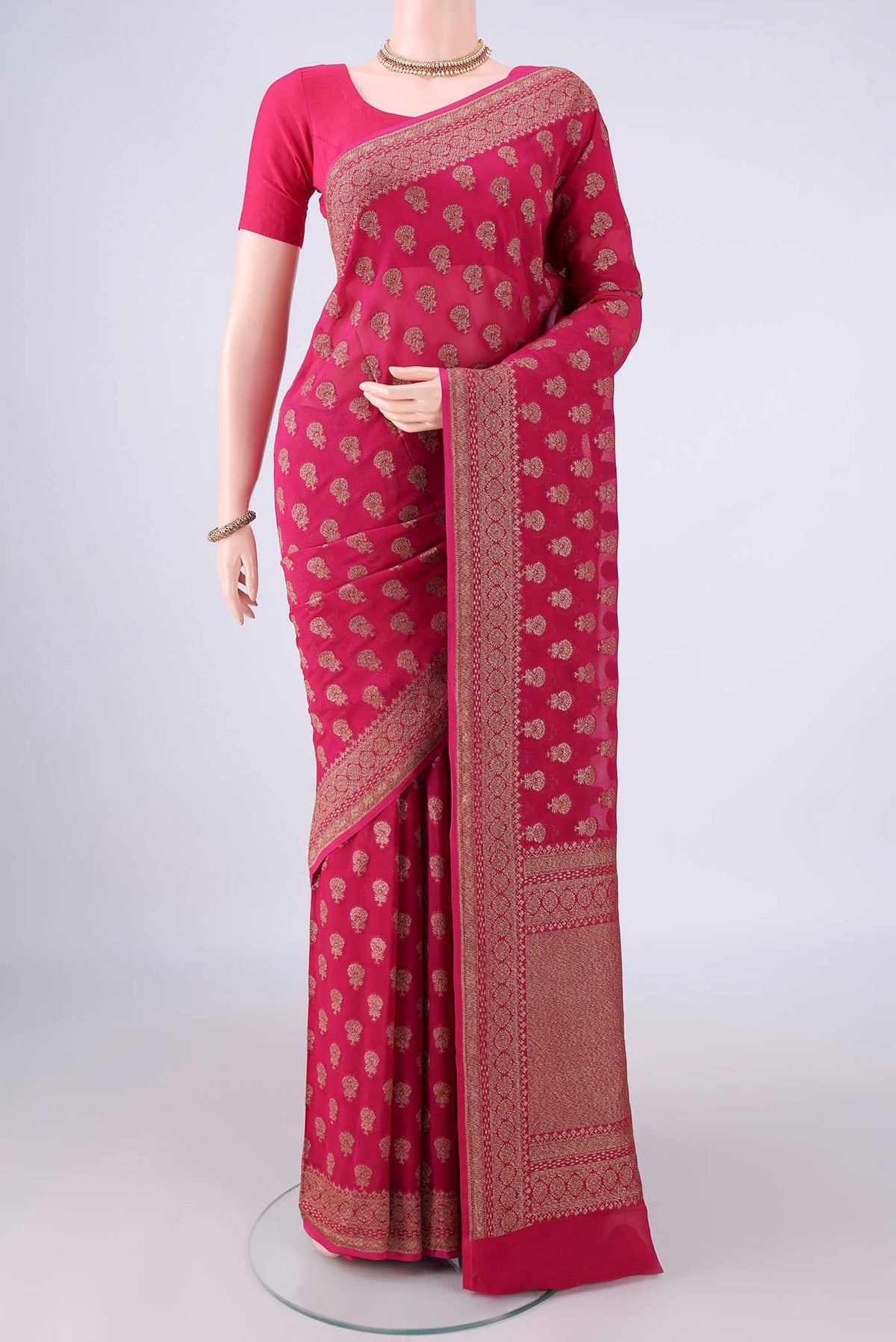 Rani Pink Banarasi Georgette Saree with Zari Butta on the body and Zari Border.  displayed on a mannequin