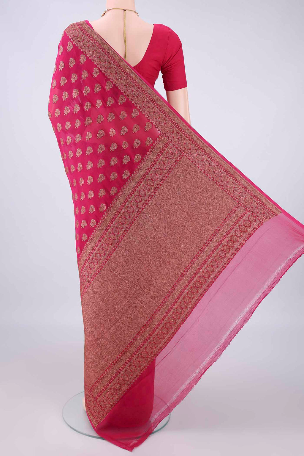 Flat view of Rani Pink Banarasi Georgette Saree with Zari Butta on the body and Zari Border. 