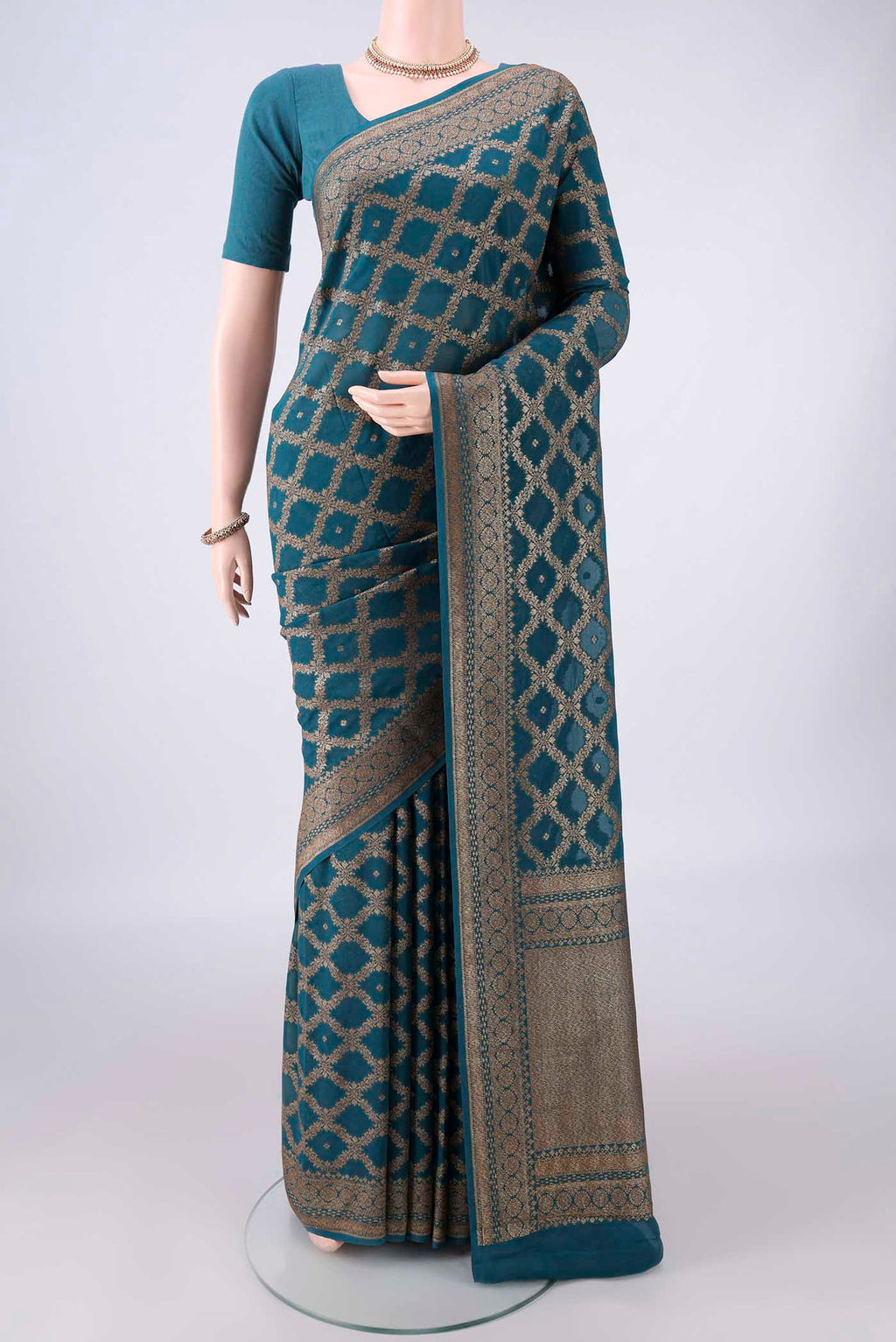 Peacock Blue Banarasi Georgette Saree with Zari Brocade on the body and Zari Border.  displayed on a mannequin