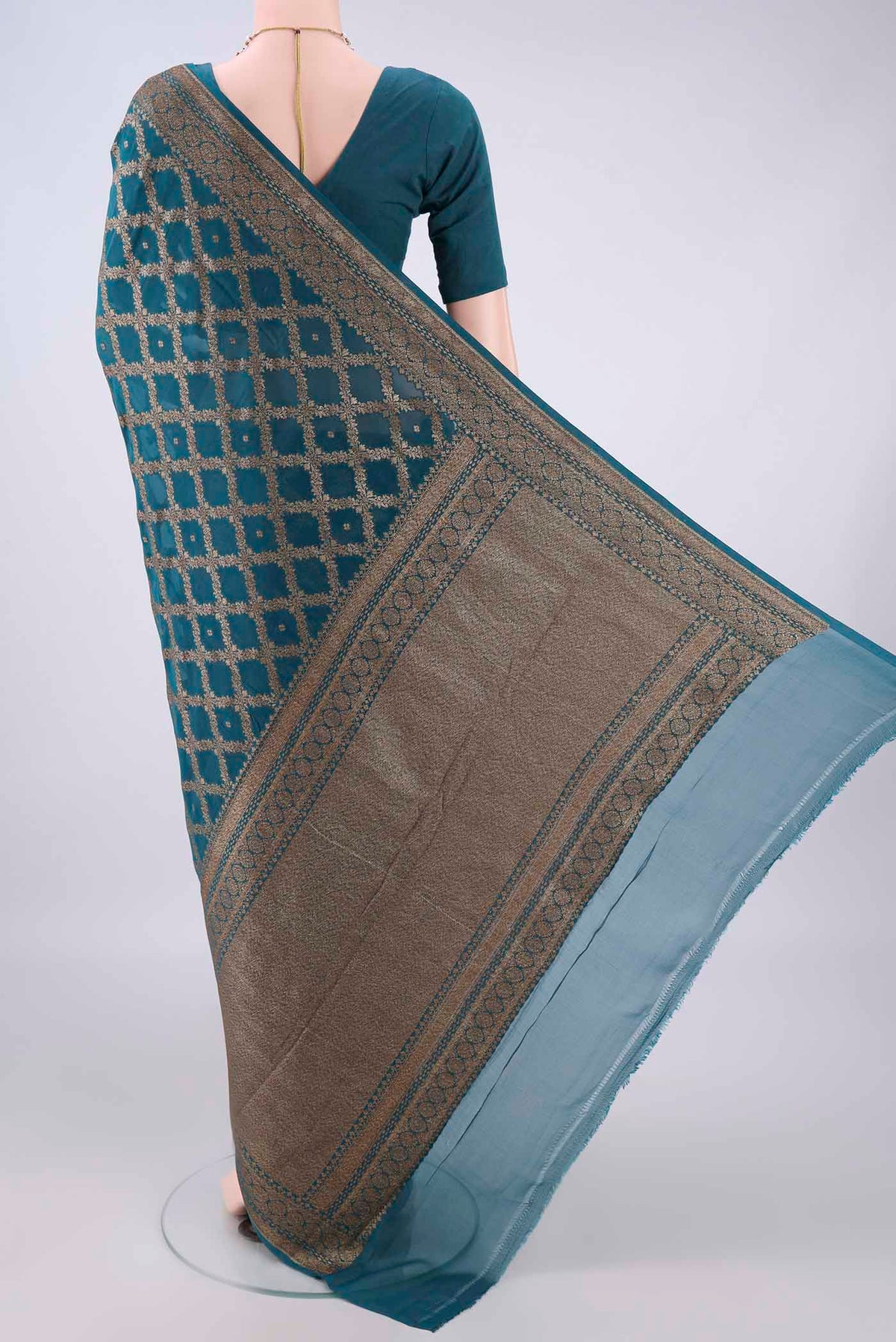 Flat view of Peacock Blue Banarasi Georgette Saree with Zari Brocade on the body and Zari Border. 