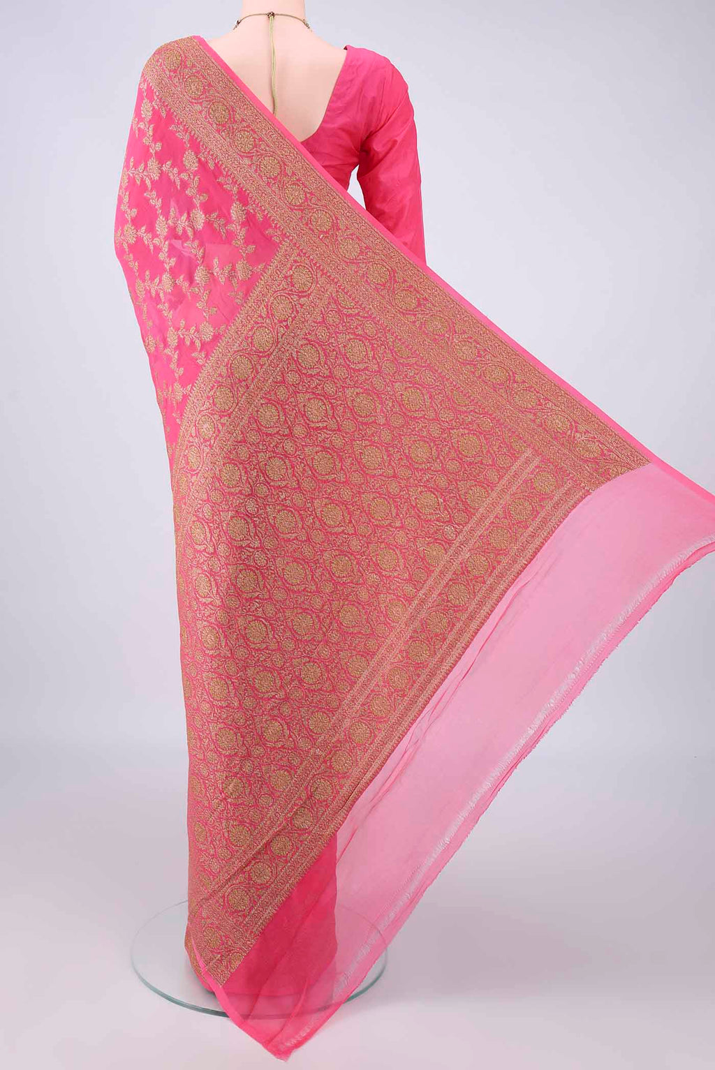 Flat view of Coral Banarasi Georgette Saree with Zari Brocade on the body and Zari Border. 