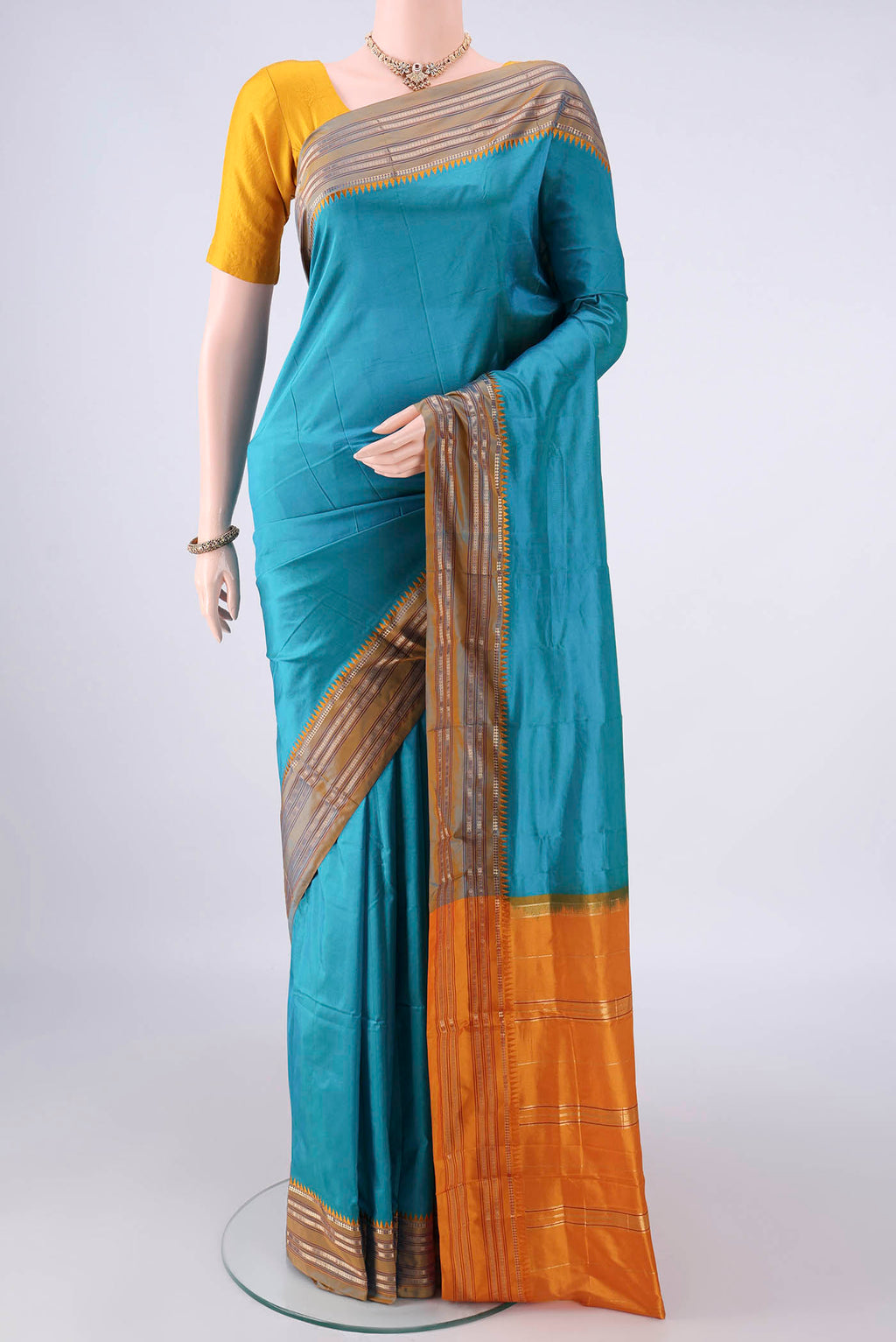 Pure Silk Sea Green Narayanpet Saree with Plain Body and Zari Border.  displayed on a mannequin