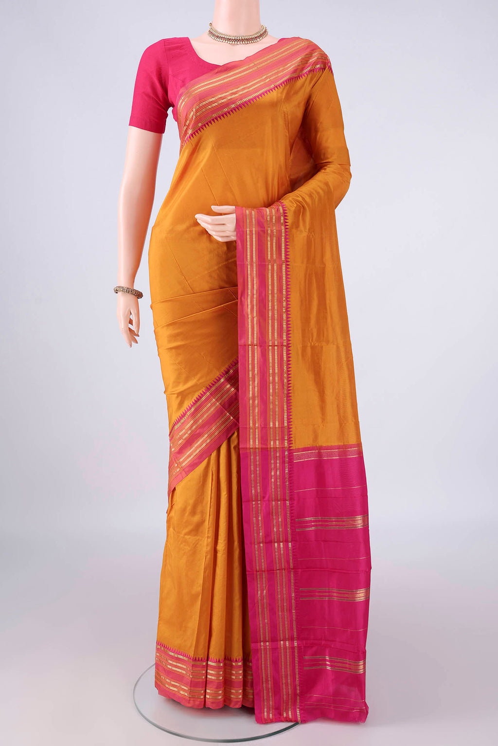 Pure Silk Mustard Narayanpet Saree with Plain Body and Zari Border.  displayed on a mannequin