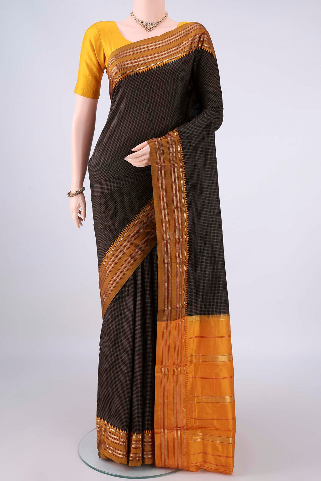 Pure Silk Black Narayanpet Saree with Checked design on the body and Zari Border.  displayed on a mannequin
