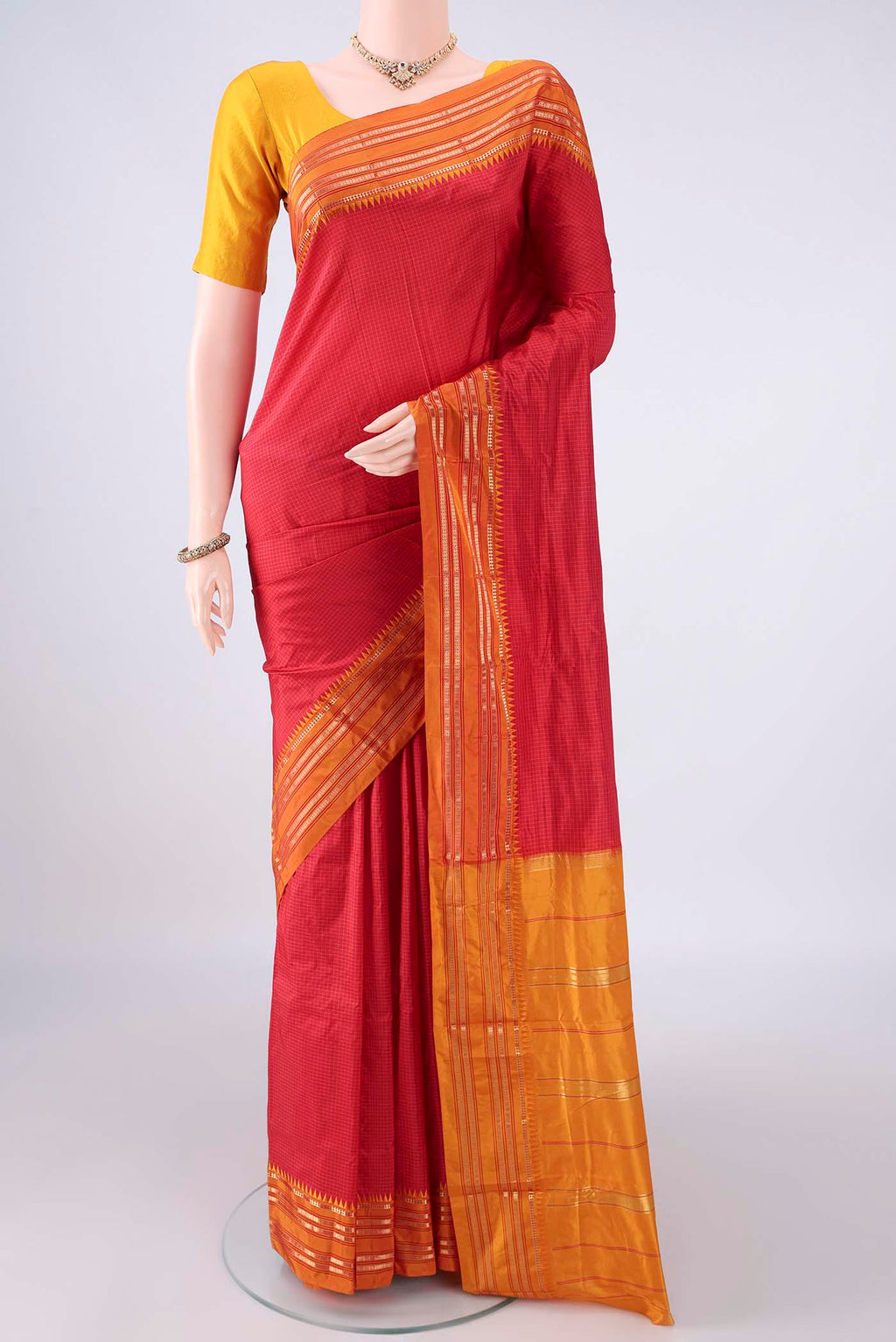 Pure Silk Red Narayanpet Saree with Checked design on the body and Zari Border.  displayed on a mannequin
