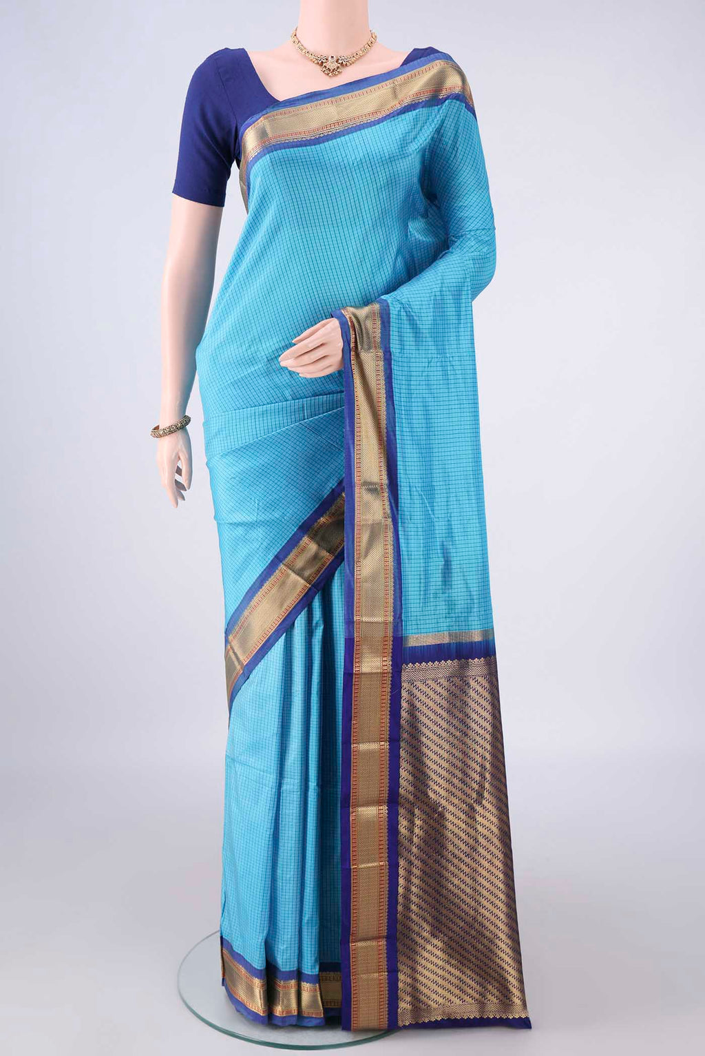 Pure Silk Sky Blue Narayanpet Saree with Checked design on the body and Zari Border.  displayed on a mannequin