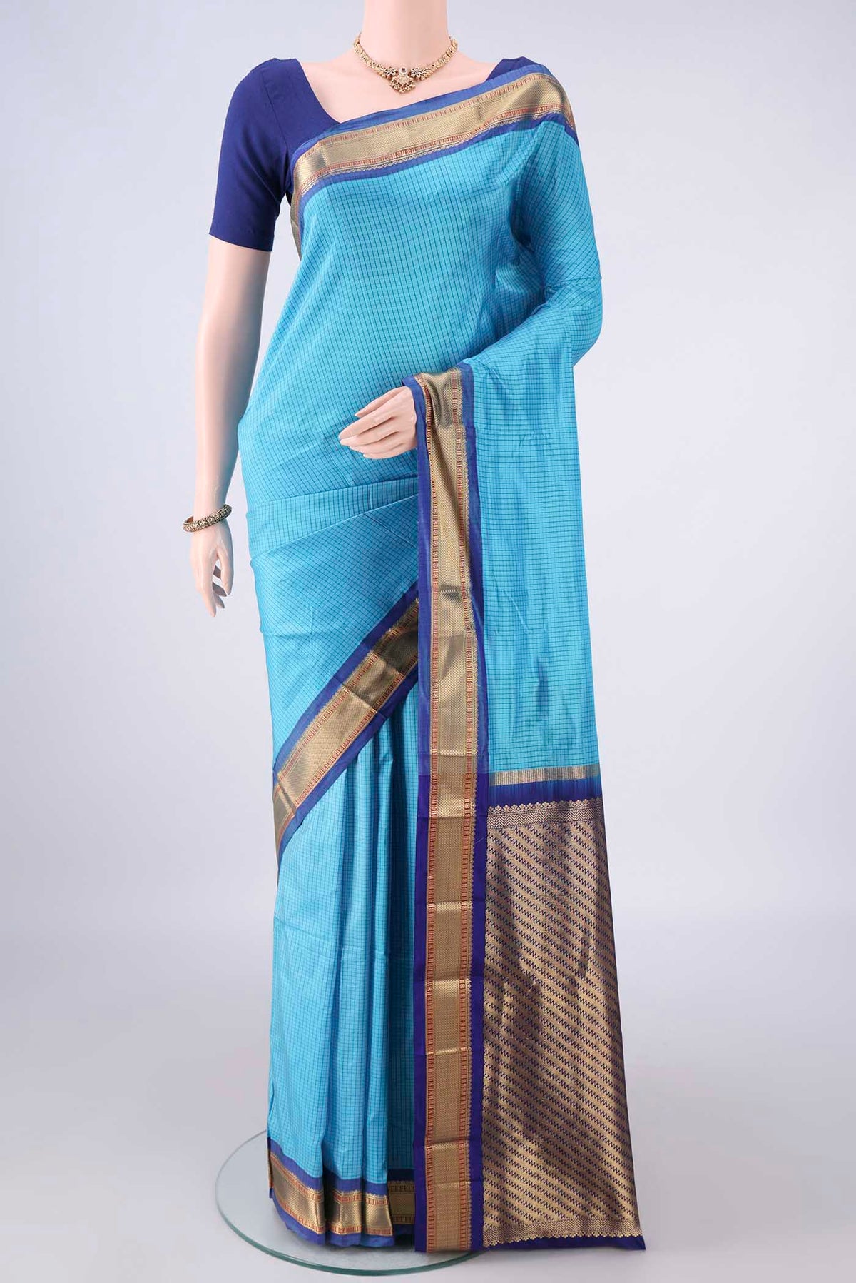 Pure Silk Sky Blue Narayanpet Saree with Checked design on the body and Zari Border.  displayed on a mannequin