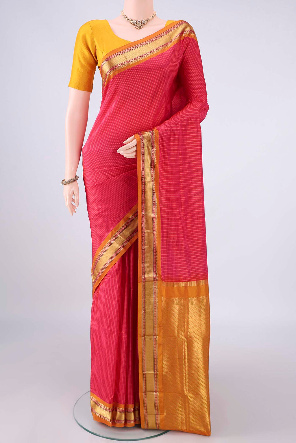 Pure Silk Coral Narayanpet Saree with Checked design on the body and Zari Border.  displayed on a mannequin