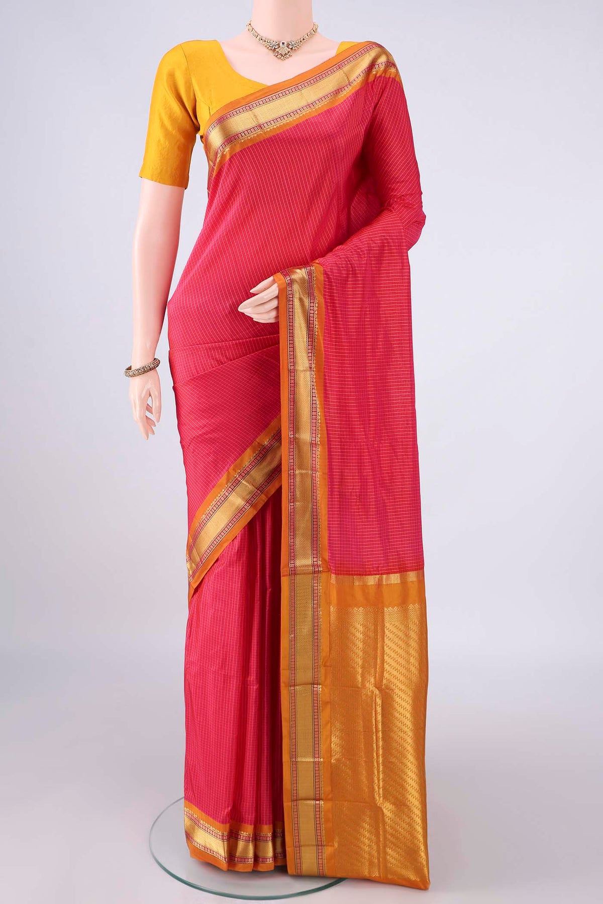 Pure Silk Coral Narayanpet Saree with Checked design on the body and Zari Border.  displayed on a mannequin